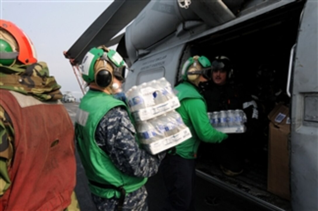 Sailors assigned to Anti-Submarine Squadron 4 load supplies onto an HH-60H Sea Hawk helicopter aboard the aircraft carrier USS Ronald Reagan (CVN 76) off the coast of Japan on March 14, 2011.  The Ronald Reagan is rendering humanitarian assistance following an earthquake and tsunami.  