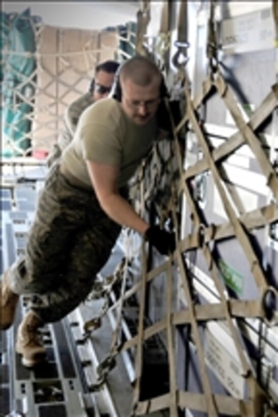 Airmen from the 89th Aerial Port Squadron load pallets onto a C-17 Globemaster III aircraft at Joint Base Andrews, Md., on March 12, 2011.  Air transportation airmen prepared 14 pallets of technical search-and-rescue gear, including inflatable swift-water rescue boats, generators, trench rescue and cutting equipment.  The gear is being transported by C-17 to provide assistance after an earthquake and tsunami hit Japan on March 11, 2011.  