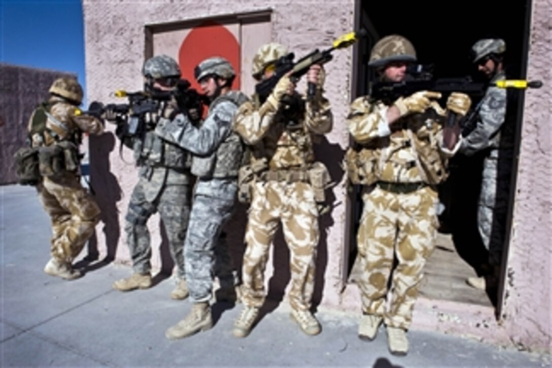U.S. Air Force airmen with the 820th Base Defense Group and British airmen with the Royal Air Force No. 1 Squadron practice clearing a building during exercise Desert Eagle at the Nevada Test and Training Range, Nev., on March 9, 2011.  Exercise Desert Eagle is designed to improve both nationsí ability to work together during present and future contingencies.  