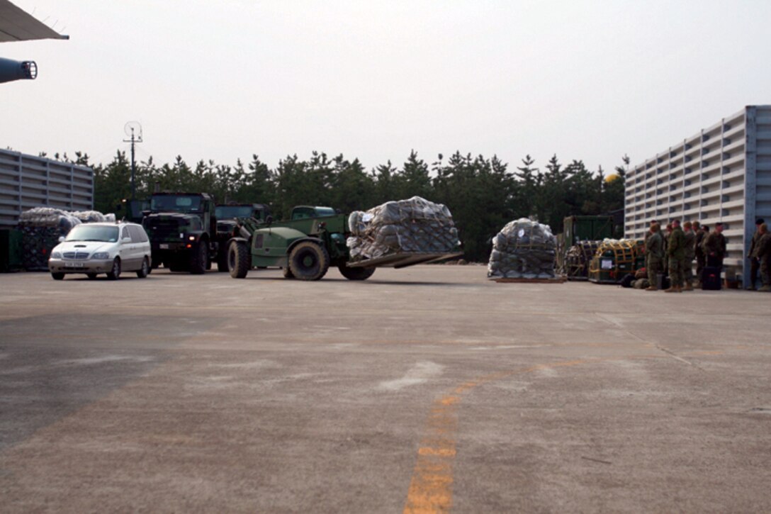 A tactical forklift hauls pallets full of communication gear used from Exercise Key Resolve to help support the humanitarian disaster relief in Japan here Mar. 15.