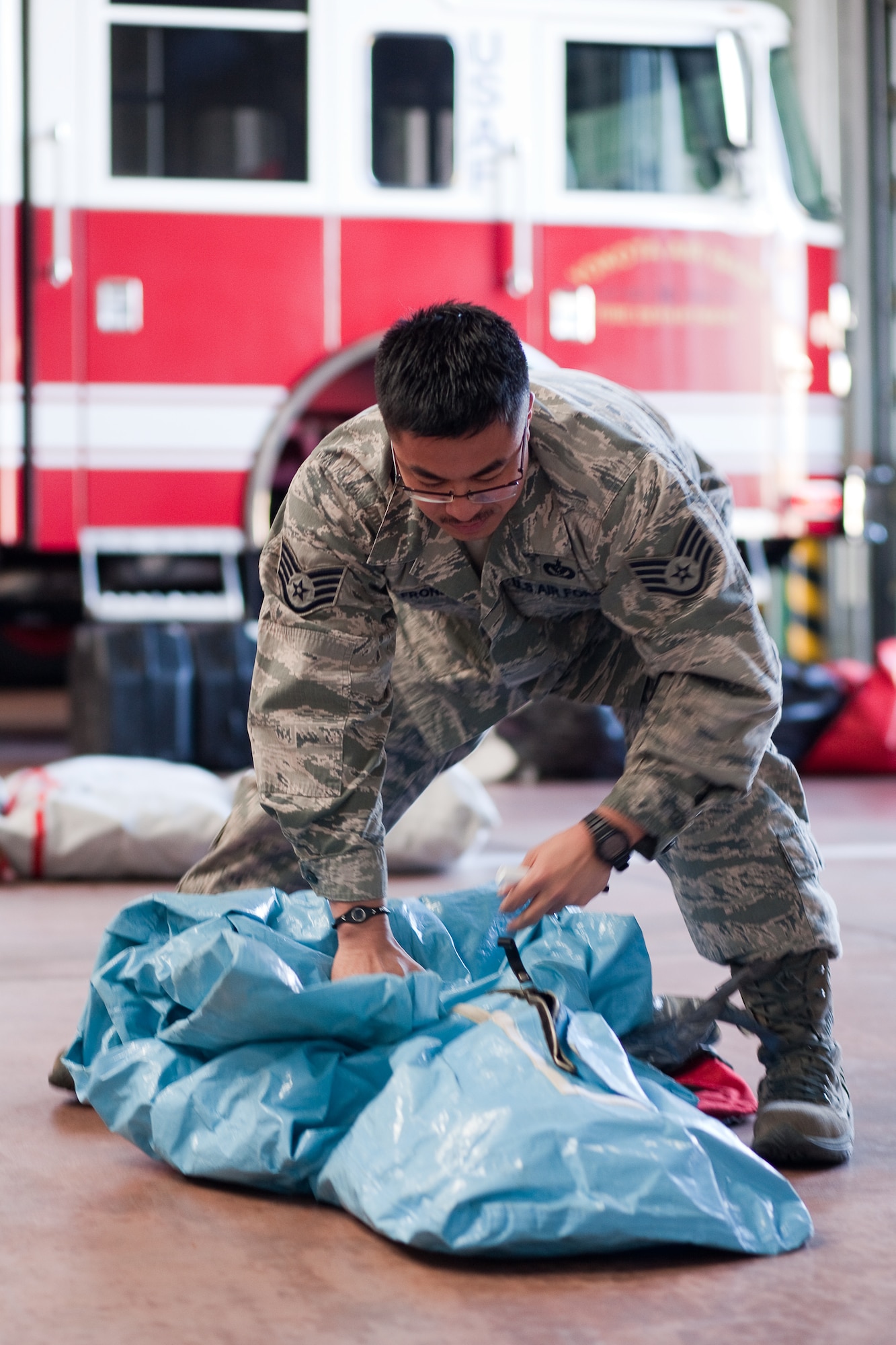 YOKOTA AIR BASE, Japan -- Tech. Sgt. Rommel Fronda, 374th Civil Engineer Squadron, packs chemical suits here March 17. The suits will be used to assist with relief efforts during Operation Tomodachi. (U.S. Air Force photo/Osakabe Yasuo) 