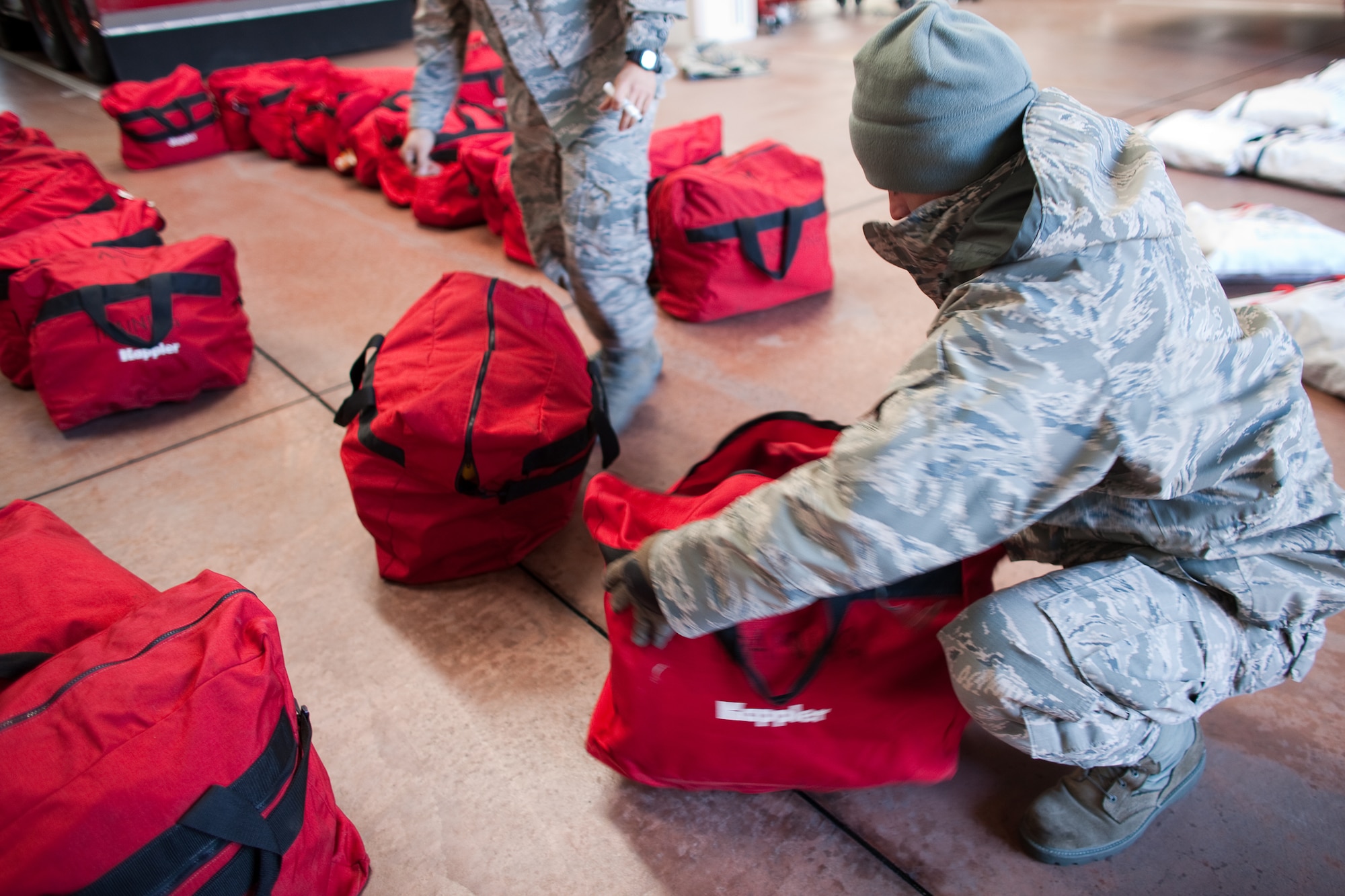 YOKOTA AIR BASE, Japan -- Senior Airman Peter Beyer, 374th Civil Engineer Squadron, inspects chemical suits here March 17. The equipment will be used to assist in relief operations in Northern Japan. (U.S. Air Force photo/Osakabe Yasuo) 