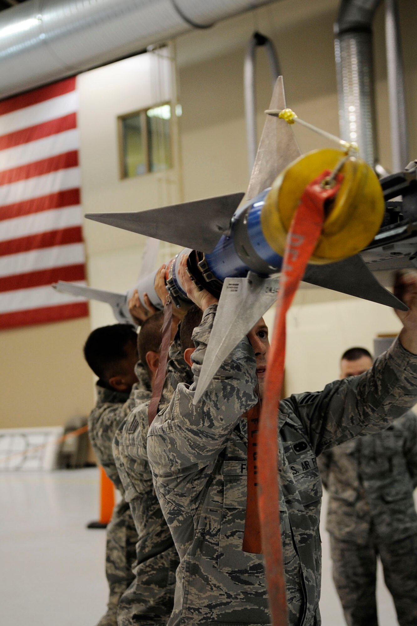 Weapons crew Airmen attach an AIM-9 L/M Sidewinder Missile to an F-16 Fighting Falcon during the annual load crew of the year competition March 11, 2011, Eielson Air Force Base, Alaska. The competition is amongst the top two weapons crews with the best year long statistics. The Airmen are assigned the 354th Aircraft Maintenance Squadron.   (U.S. Air Force photo/Airman 1st Class Laura Goodgame)