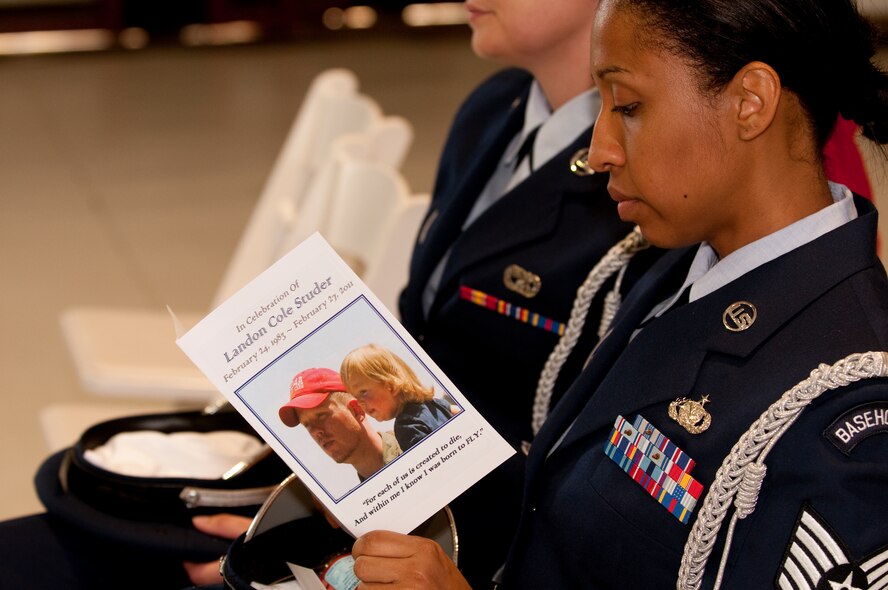 Air Force Tech. Sgt. Olympia Williamson, 136th Airlift Wing, Base honor guard, reads about former Guard member Landon Studer who was killed in an aircraft accident while deployed as a contractor to the Middle east on Feb.27, 2011. Studer was given an honorable military funeral due to  his veteran status when he served in support of Operation Enduring Freedom from 2005 to 2010 in the Texas Air National Guard and Air Force Reserves. (U.S. Air Force photo by Senior Master Sgt. Elizabeth Gilbert/released)