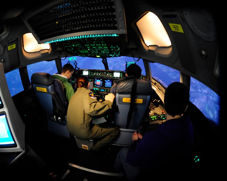 Students of Emerald Ridge High School experience C-17 Globemaster III training in the simulator with the help of 1st Lt. Diana Dillard, 8th Airlift Squadron pilot, March 11, 2011, at Joint Base Lewis-McChord, Wash. (U.S. Air Force Photo/Adamarie Lewis-Page) 