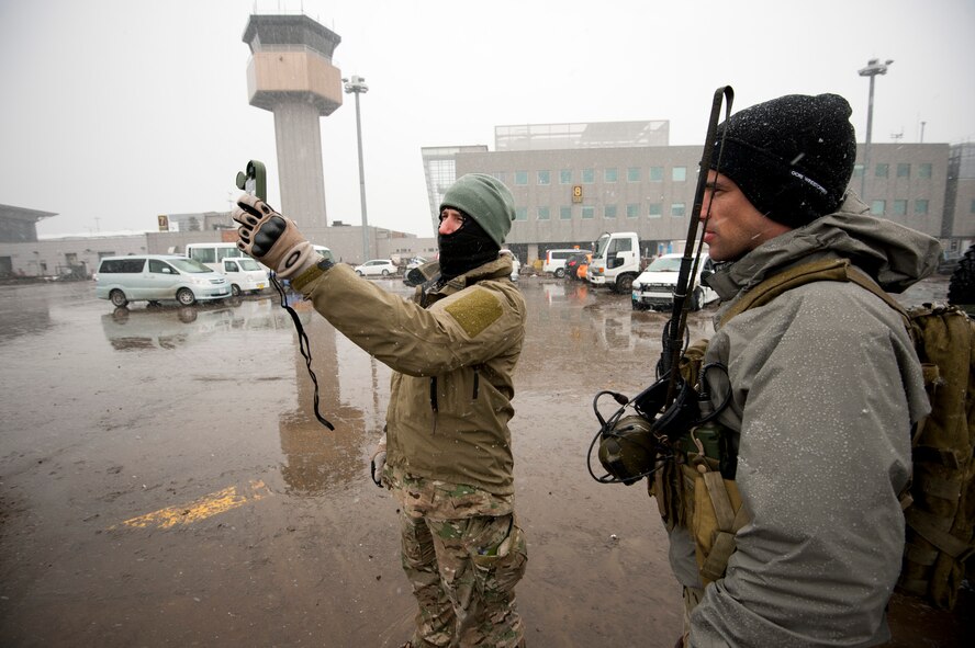 SENDAI AIRPORT, Japan -- Staff Sgt. Chris Allen, 320th Special Tactics Squadron special operations weather team, checks the windspeed and temperature here March 16. Sudden snow and low visibility threatened to prevent aircraft from landing at the airfield. (U.S. Air Force photo/Staff Sgt. Samuel Morse)