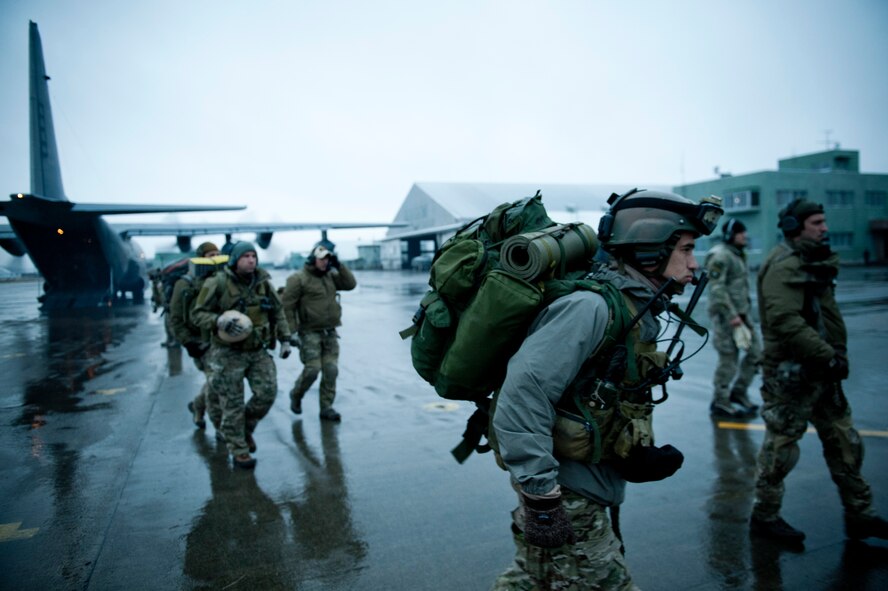 MATSUSHIMA AIR BASE, Japan -- Airmen from the 320th Special Tactics Squadron exit an MC-130P Combat Shadow on their way to Sendai Airport here March 16. Members of the 320th STS, stationed out of Kadena Air Base, deployed to Sendai Airport to help clear the runway and make it ready for fixed-wing aircraft traffic. (U.S. Air Force photo/Staff Sgt. Samuel Morse)