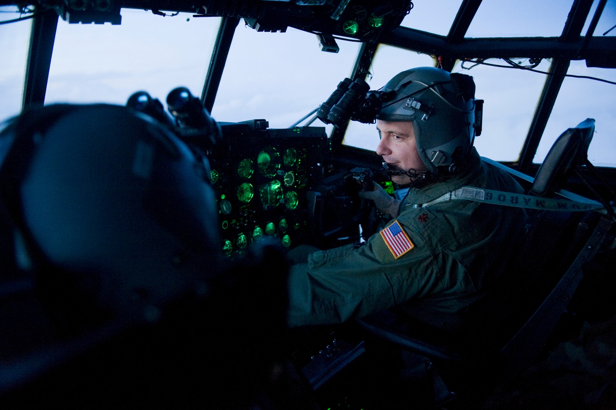 YOKOTA AIR BASE, Japan -- Maj. Kerry Redman, 17th Special Operations Squadron, flies toward Sendai Airport to drop off supplies March 16. The crew brought water, food, fuel and other general supplies to the members of the 353rd Special Operations Group at Sendai for search and rescue missions. The 353rd Special Operations Group is establishing a usable runway at Sendai Airport to help with Japan's earthquake and tsunami relief. (U.S. Air Force photo/Staff Sgt. Jonathan Steffen)