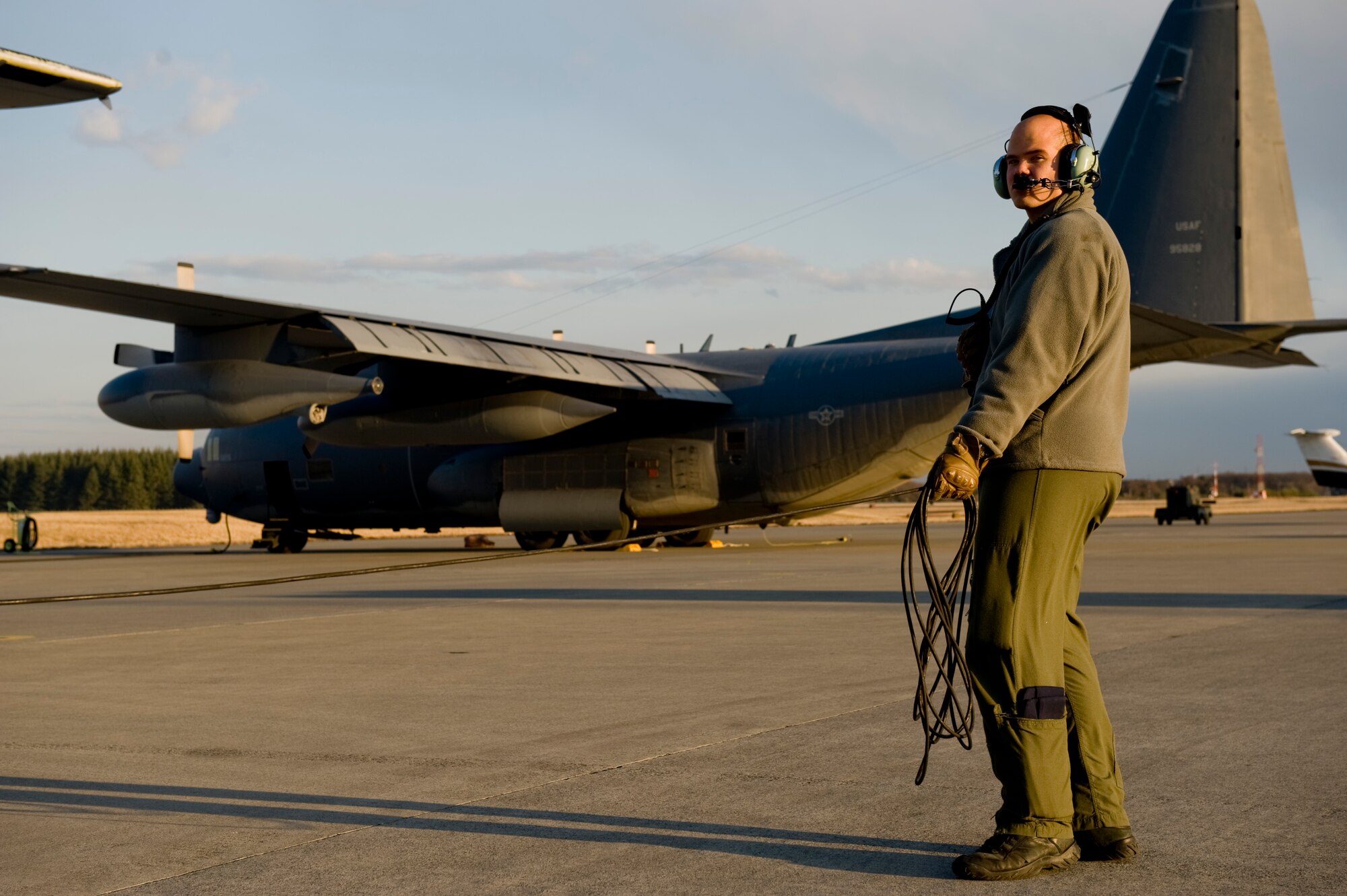 YOKOTA AIR BASE, Japan -- Senior Airman Ramon Mortensen, 17th Special Operations Squadron, communicates with pilot about start up procedures before heading out to Sendai Airport March 16. The crew brought water, food, fuel and other general supplies to the members of the 353rd Special Operations Group at Sendai for search and rescue missions. The 353rd Special Operations Group is establishing a usable runway at Sendai Airport to help with Japan's earthquake and tsunami relief. (U.S. Air Force photo/Staff Sgt. Jonathan Steffen)