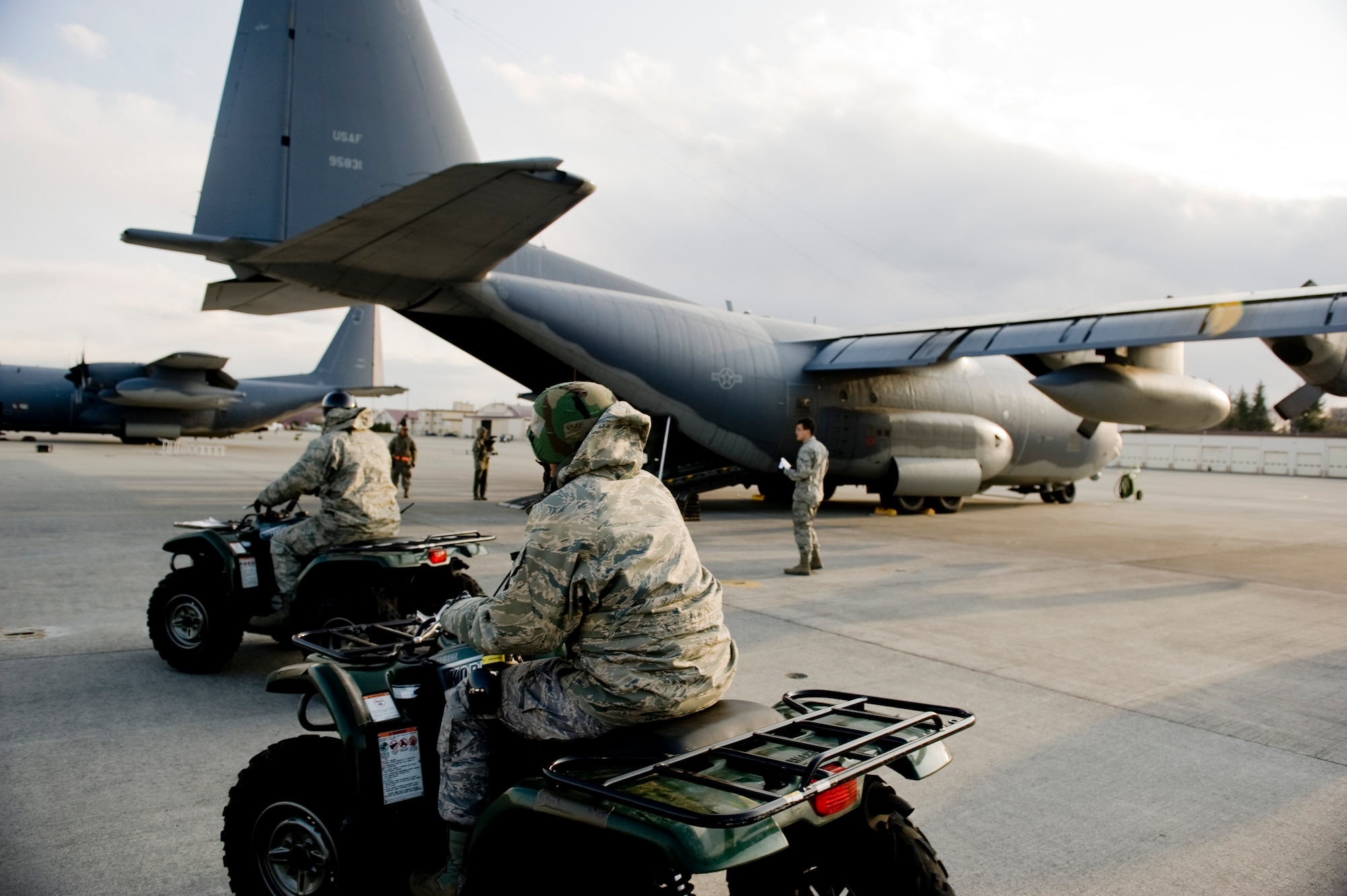 YOKOTA AIR BASE, Japan -- Senior Bradley Collier and Staff Sgt. Amber Anderson both from the 374 Logistics Readiness Squadron, drive toward an MC-130P.  (U.S. Air Force photo/Staff Sgt. Jonathan Steffen)