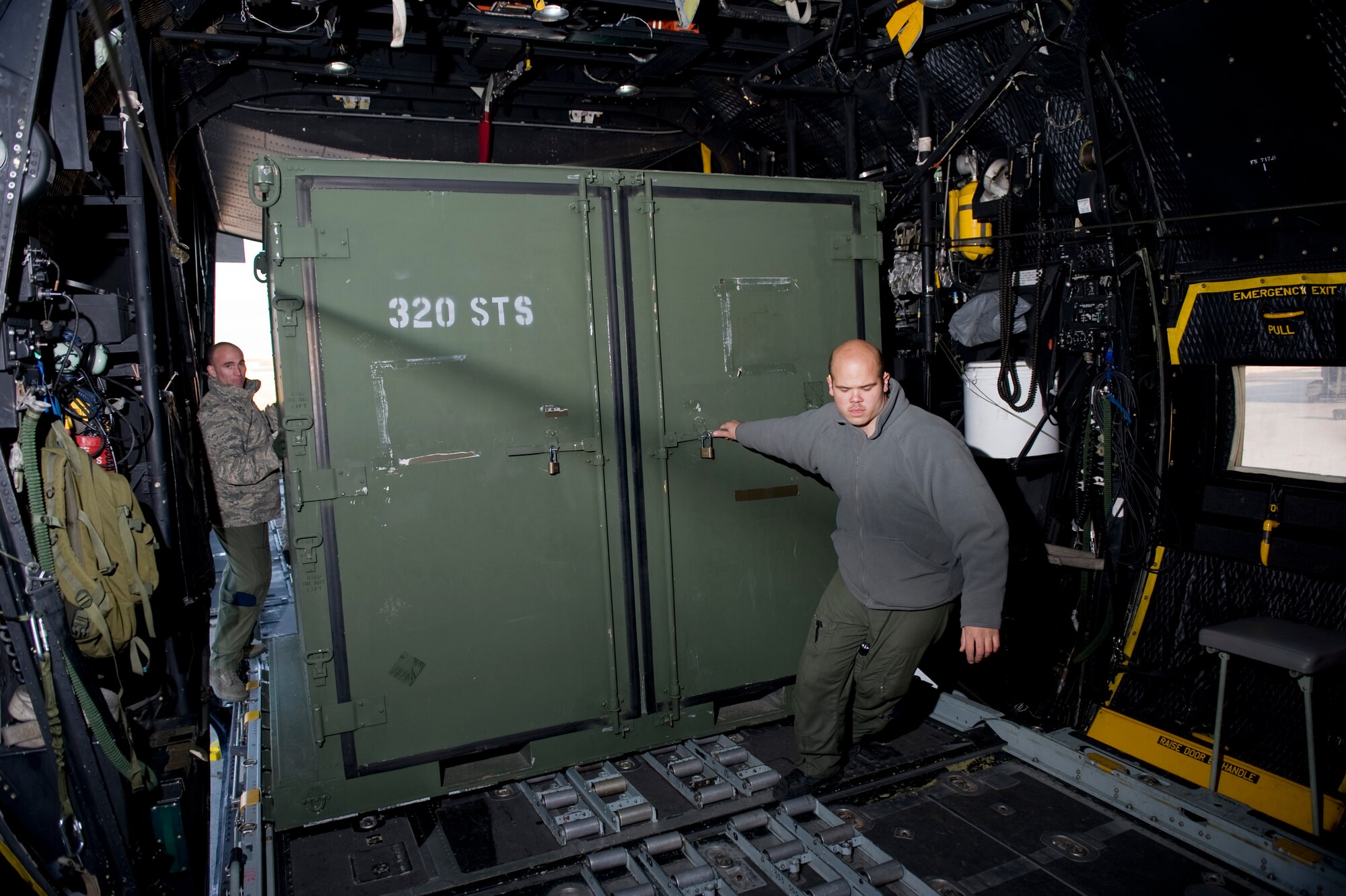 YOKOTA AIR BASE, Japan -- Master Sgt. Mike Milich and Senior Airman Ramon Mortensen both from the 17th Special Operations Squadron, pull supplies on board a MC-130P prior to heading out to Sendai Airport March 16. The crew brought water, food, fuel and other general supplies to the members of the 353rd Special Operations Group at Sendai for search and rescue missions. The 353rd Special Operations Group is establishing a usable runway at Sendai Airport to help with Japan's earthquake and tsunami relief. (U.S. Air Force photo/Staff Sgt. Jonathan Steffen)