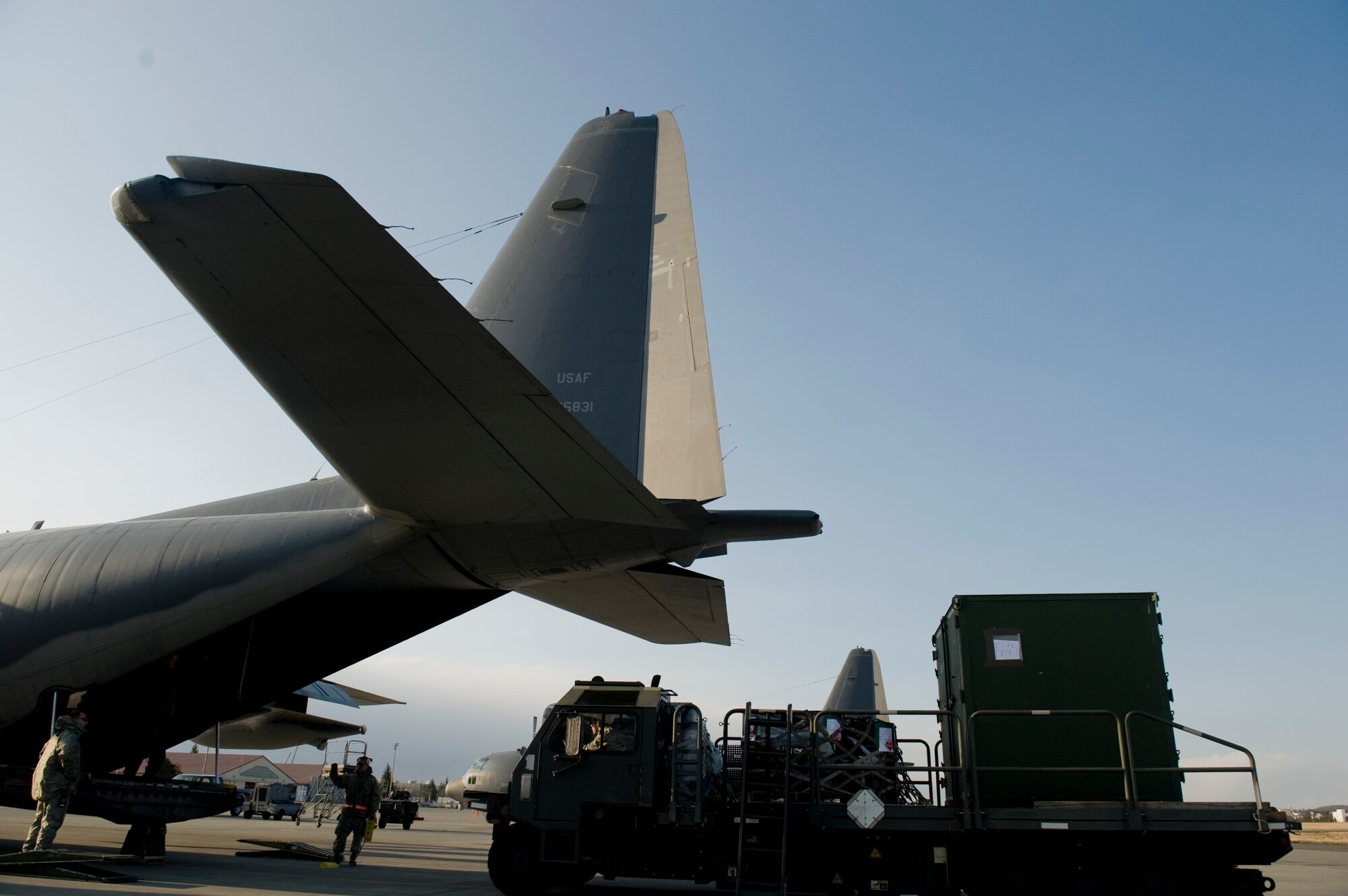 YOKOTA AIR BASE, Japan -- Supplies of water, fuel and food are loaded onto a MC-130P for transport to Sendai Airport March 16. The supplies were delivered to sustain members of the 353rd Special Operations Group during search and rescue missions. (U.S. Air Force photo/Staff Sgt. Jonathan Steffen)