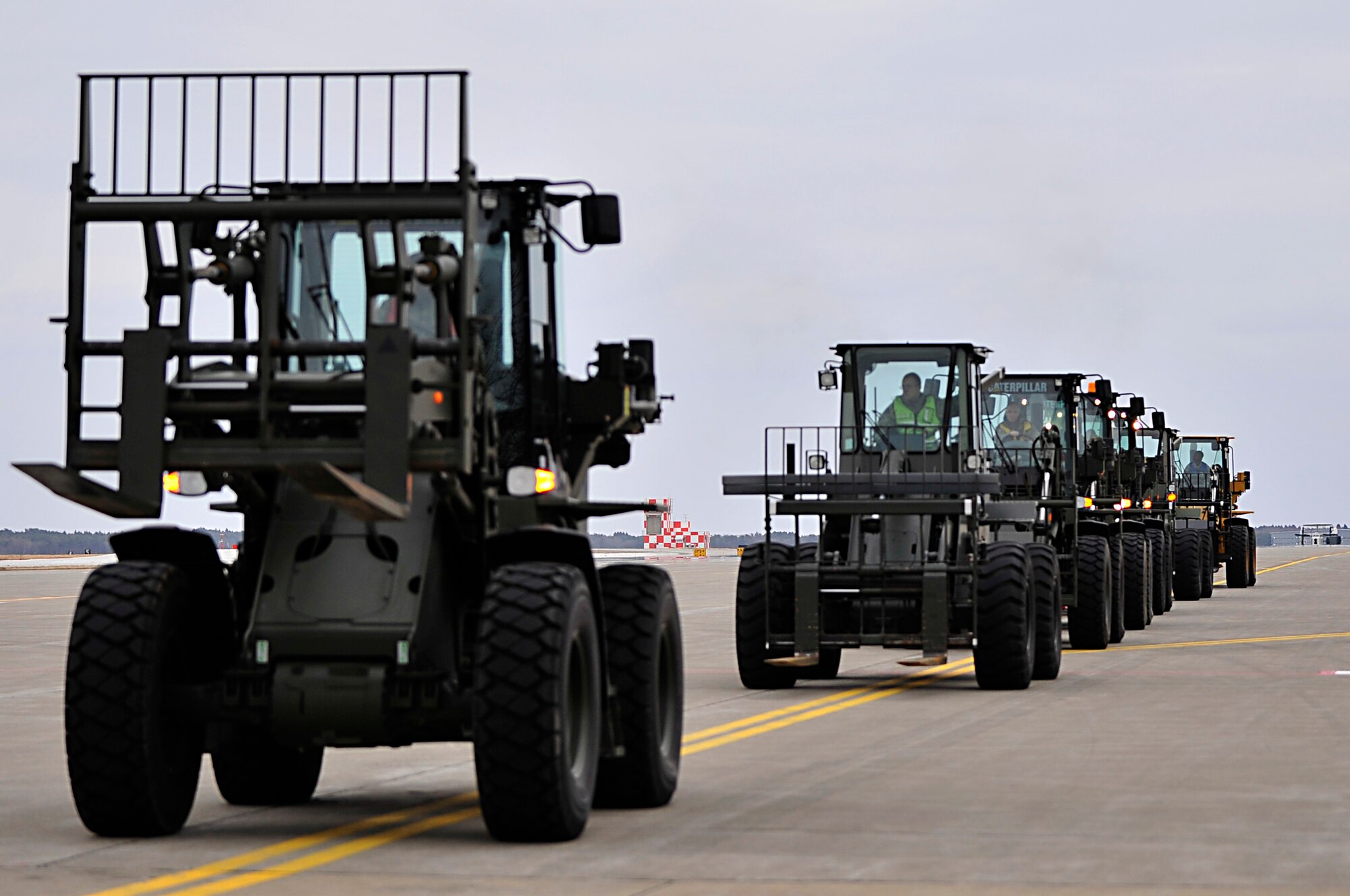 Airmen from the 35th Logistics Readiness Squadron at Misawa Air Base, Japan, prepare to off-load cargo March 15, 2011, from arriving aircraft. The cargo load teams are responsible for safely moving passengers and cargo around the flight line. (U.S. Air Force photo/Staff Sgt. Marie Brown) 