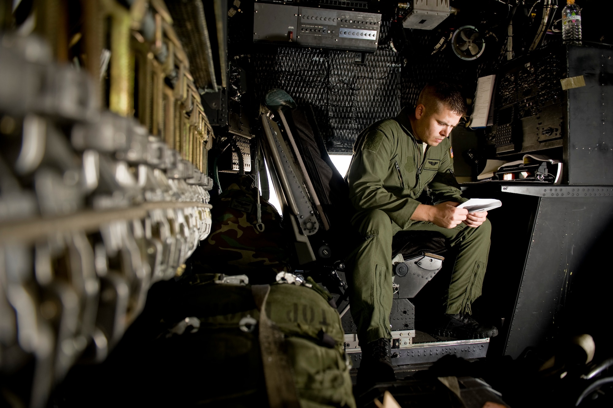 YOKOTA AIR BASE, Japan -- Staff Sgt. Curtis Hornbeak, 17th Special Operations Squadron, reviews a flight operations guide prior to departing for Sendai Airport March 16. The crew brought water, food, fuel and other general supplies to the members of the 353rd Special Operations Group at Sendai for search and rescue missions. The 353rd Special Operations Group is establishing a usable runway at Sendai Airport to help with Japan's earthquake and tsunami relief. (U.S. Air Force photo/Staff Sgt. Jonathan Steffen)