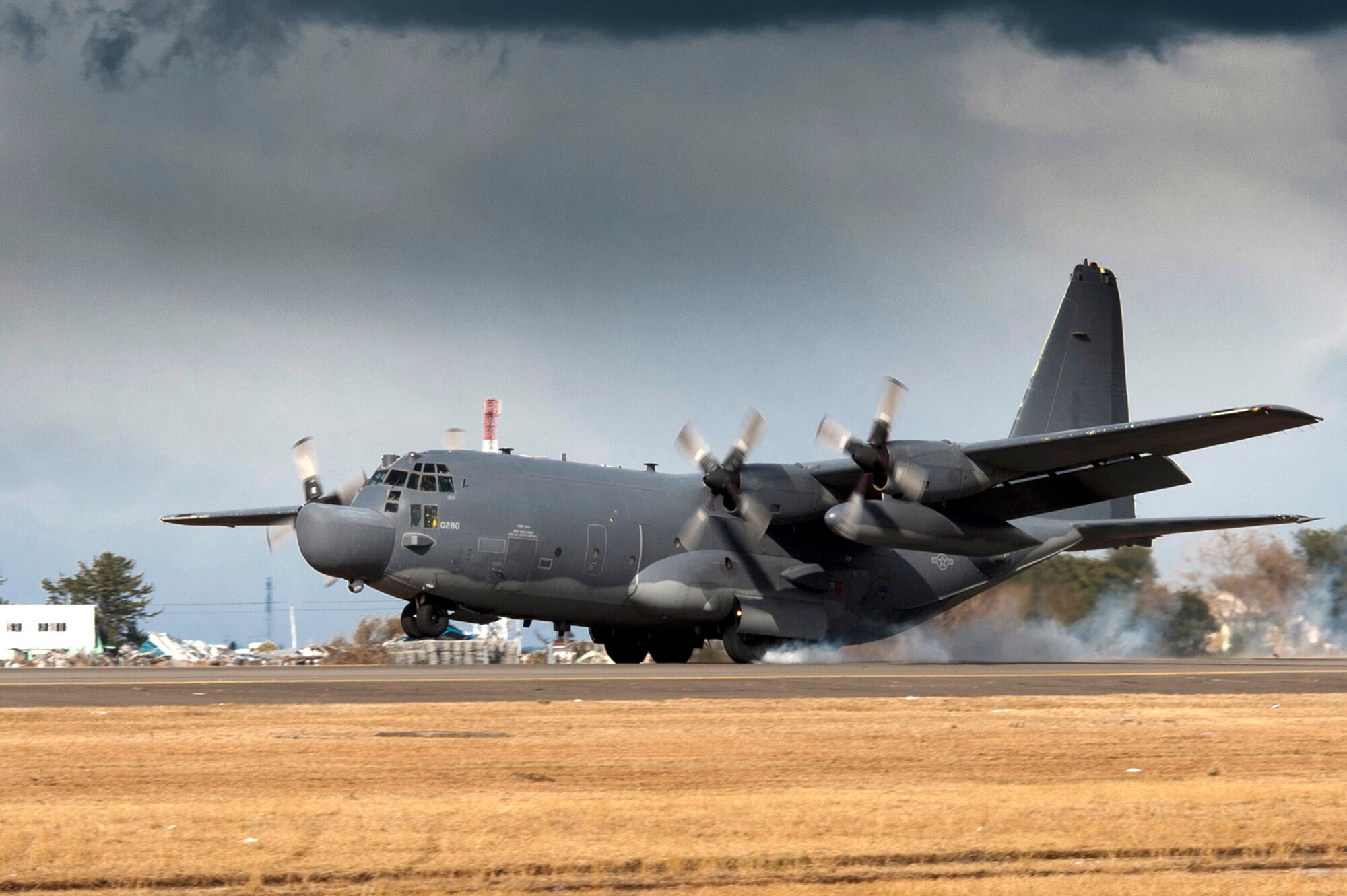 An MC-130H Combat Talon II lands March 16, 2011 at Sendai Airport, Japan. This is the first fixed-wing aircraft to land at the airport since an earthquake and tsunami crippled much of the Japanese eastern seaboard March 11. A team of combat controllers from the 320th Special Tactics Squadron, out of Kadena Air Base, Japan, along with Japanese emergency management organizations, cleared a section of the runway and re-established the control tower to direct flights in and out of the airfield. (U.S. Air Force photo/Staff Sgt. Samuel Morse)