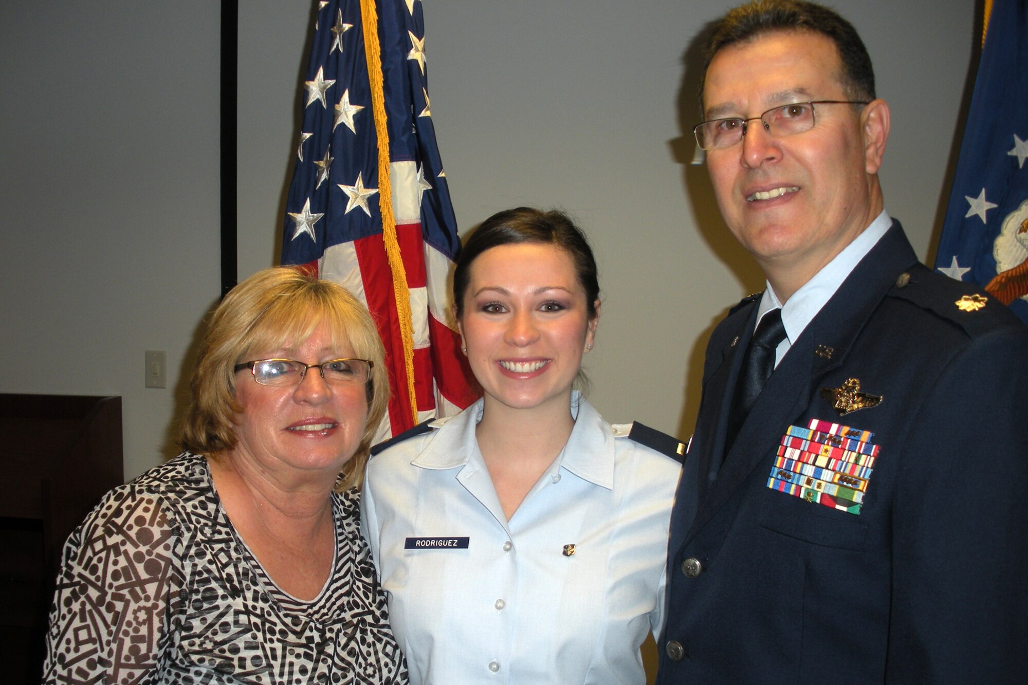 Sandy Rodriguez, 2nd Lt. Beverly S. Rodriguez and Lt. Col. Rafael Rodriguez, B-52 radar navigator, 343rd Bomb Squadron, Barksdale Air Force Base, La., pose for a family photo after the Colonel enlisted his daughter into the Air Force at the health recruiter's office in Arlington, Texas, Feb. 16, 2011. Lieutenant Rodriguez graduated as a registered nurse from Midwestern State University - Wichita Falls, Texas in Dec 2010, and is presently attending commissioning officer training (COT) at Maxwell, Air Force Base, Ala.  Following COT Lieutenant Rodriguez will attend a 10-week Air Force Nurse Training Program at Keesler Air Force Base, Miss., before reporting to the 96th Inpatient Operations Squadron at Eglin Air Force Base, Fla., where she will be assigned as a registered nurse. (Courtesy photo)