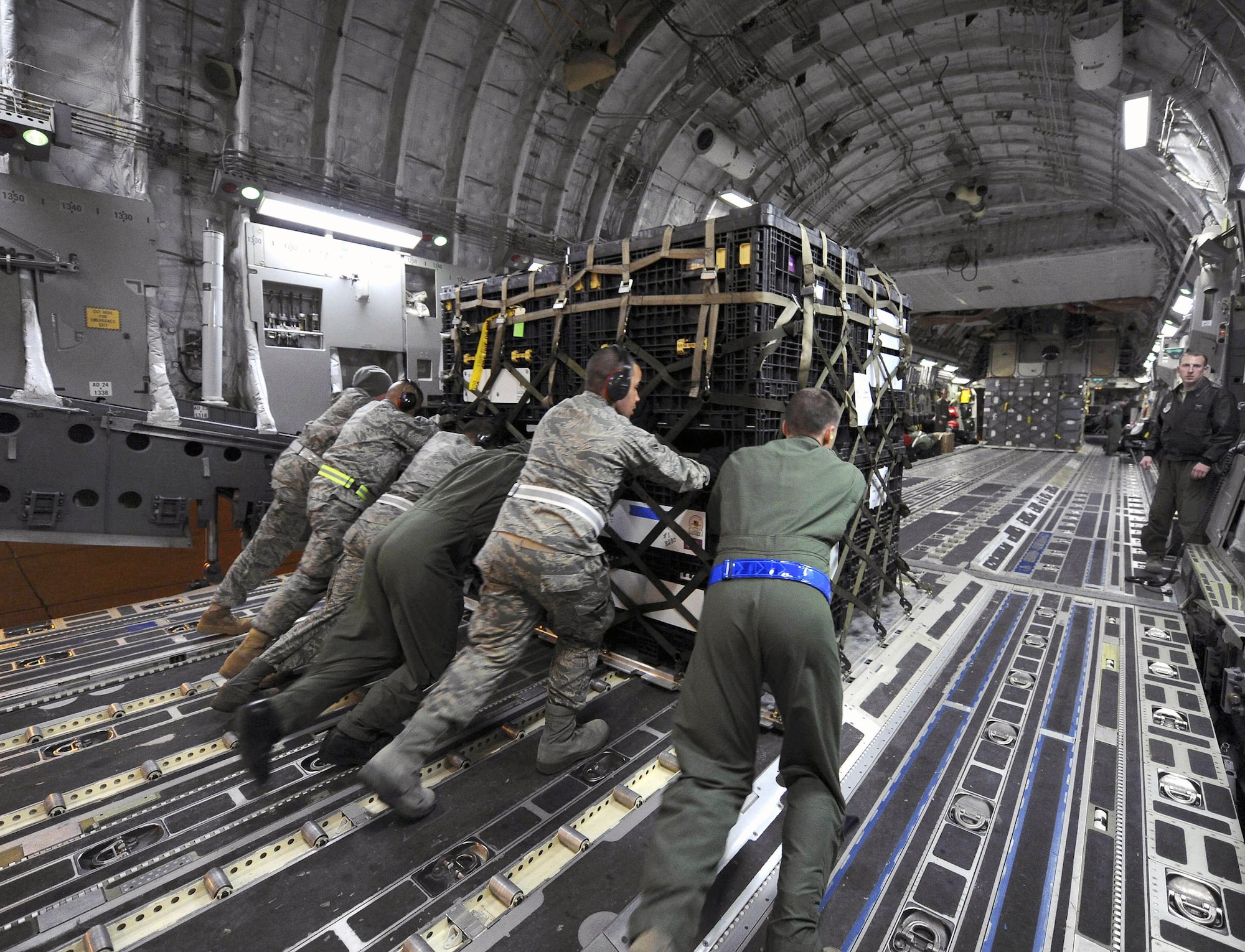 U.S. Air Force airmen load a pallet onto a U.S. Air Force C-17A Globemaster III at March Air Reserve Base, Calif., on March 12, 2011.  The supplies are en route to Japan for earthquake relief efforts.  (DoD photo by Staff Sgt. Matthew Smith, U.S. Air Force) (Released)