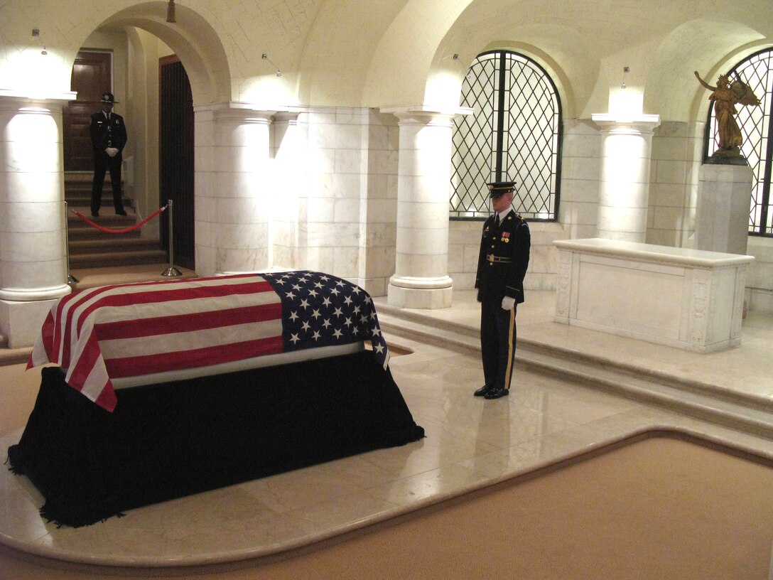A soldier with the Army’s 3rd Infantry Regiment, “The Old Guard,” keeps a constant vigil over the casket of Army Cpl. Frank Woodruff Buckles, the last U.S. World War I veteran, as he laid in repose before his burial March 15, 2011, at Arlington National Cemetery. A gold-leafed “Winged Victory” figure presented to President Warren G. Harding when the unknown soldier of World War I was buried at Arlington on Nov. 11, 1921 watches over Mr. Buckles’ casket. (Defense Department photo/Donna Miles)