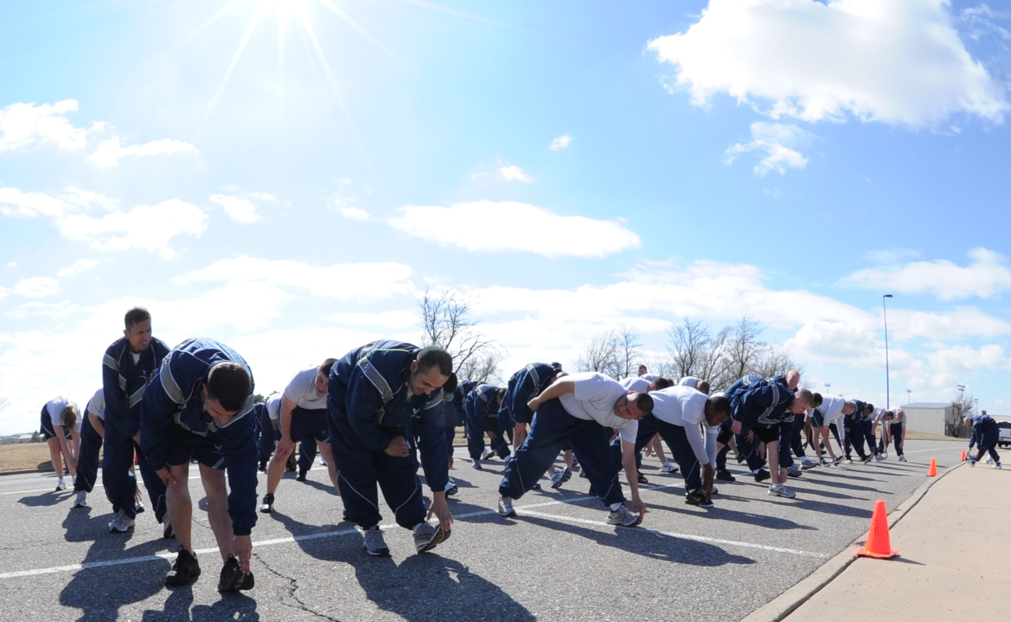 Team McConnell Airmen stretch before a quarterly wing run March 14, 2011, McConnell Air Force Base, Kan. The wing run’s focus is on unit formation and the principles of mutual support. It boosts physical fitness, morale and fosters esprit de corps. (U.S. Air Force photo/Airman 1st Class Katrina M. Brisbin)