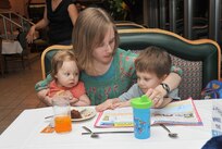 Eighmey Engle spends time with her children during the Airman and Family Readiness Center's Meet and Eat dinner at the Rodney Gott dining facility Feb. 24. Mrs. Engle's husband, 1st Lt. Nicholas Engle, is with the 91st Network Warfare Squadron. (U.S. Air Force photo/Alan Boedeker)