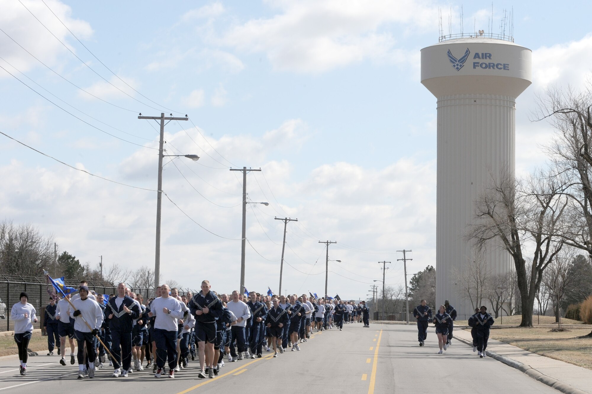 McConnell Airmen run in formation during the quarterly wing run, March 14, 2011, McConnell Air Force Base, Kan. Airmen ran approximately two miles at a 10- minute pace through the base. All wing squadrons participated in the run to boost morale and foster esprit de corps. (U.S. Air Force photo/Staff Sgt. Dallas Edwards)