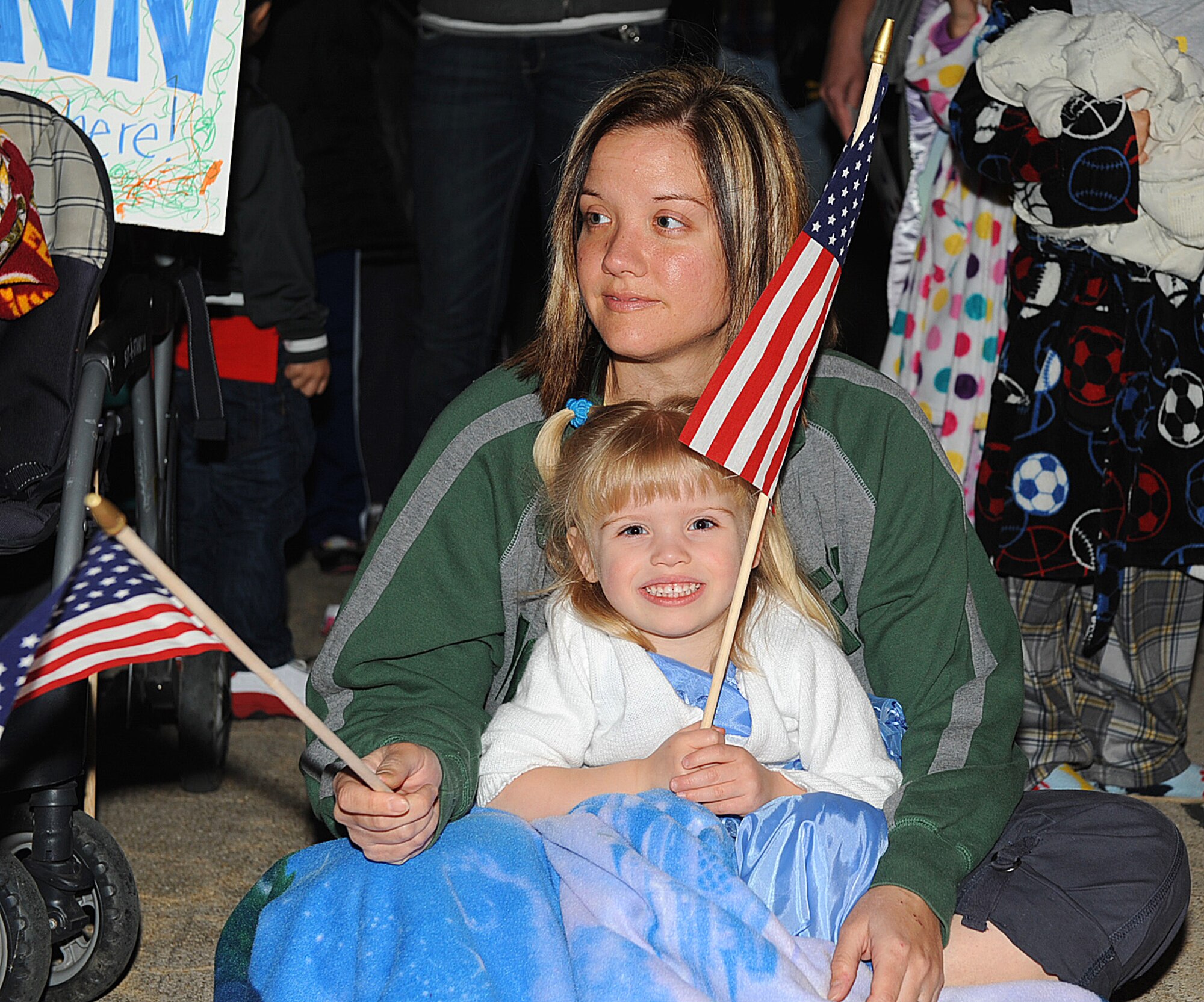 SEYMOUR JOHNSON AIR FORCE BASE, N.C. – Military spouse Leslie Worzalla and daughter Laney wait for Staff Sgt. Eric Worzalla to return home from a deployment March 15, 2011. Worzalla is attached to the 4th Aircraft Maintenance Squadron. Approximately 300 Airmen from the 336th Fighter Squadron, 4th Aircraft Maintenance Squadron, 4th Component Maintenance Squadron and the 4th Equipment Maintenance Squadron returned from a deployment to Afghanistan in support of Operation Enduring Freedom. (U.S. Air Force photo/ Senior Airman Gino Reyes)(RELEASED)