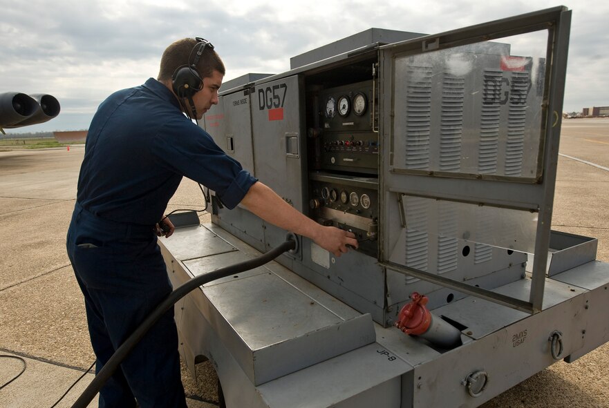 Airman 1st Class Brandon Marlow, 2nd Aircraft Maintenance Squadron crew chief, adjusts a power cart during a ground refuel of a B-52H Stratofortress on the flightline at Barksdale Air Force Base, La., March 16. The cart provides power to the aircraft instruments when the engines are not running. (U.S. Air Force photo/Senior Airman Chad Warren)(RELEASED)