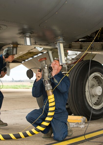 Airman 1st Class Drew Van Dyk, 2nd Aircraft Maintenance Squadron crew chief, attaches a fuel hose to a B-52H Stratofortress during a ground refuel on the flightline at Barksdale Air Force Base, La., March 16. The B-52 is also capable of in-flight refueling, giving it a much longer range and increased combat capability. (U.S. Air Force photo/Senior Airman Chad Warren)(RELEASED)