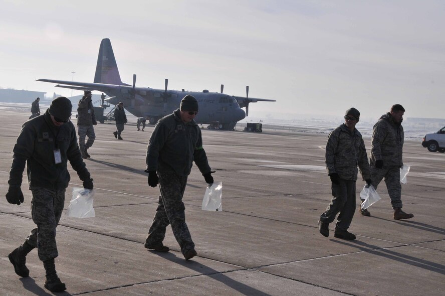 934th Airlift Wing members perform a Foreign Object Damage walk March 16 to collect potentially damaging debris from the ramp at the Minneapolis-St. Paul IAP Air Reserve Station. (Air Force Photo/Paul Zadach)