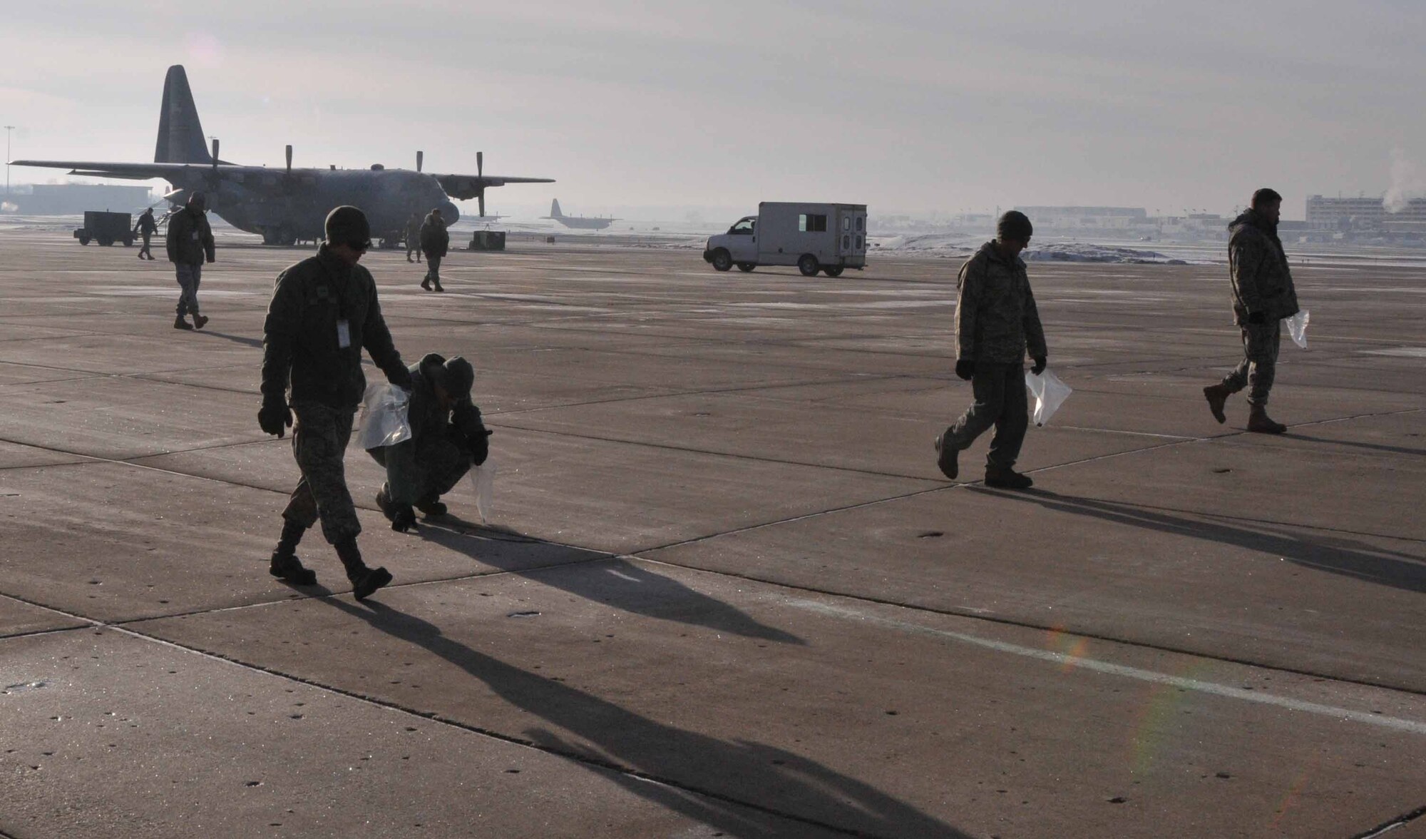 934th Airlift Wing members perform a Foreign Object Damage walk March 16 to collect potentially damaging debris from the ramp at the Minneapolis-St. Paul IAP Air Reserve Station. (Air Force Photo/Paul Zadach)