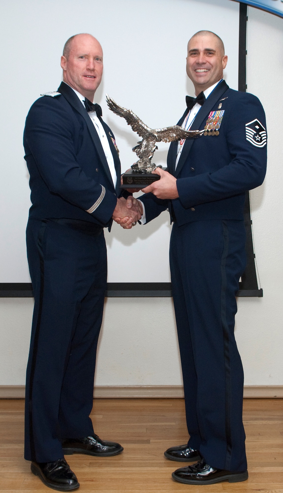Brig. Gen. Robert C. Nolan II, commander, Air Force Flight Test Center, awards Master Sgt. Phillip M. Gettins, first sergeant, 412th Test Wing Operations Group, the AFFTC First Sergeant of the Year Award, March 12. (Air Force photo by Michael Yncera)