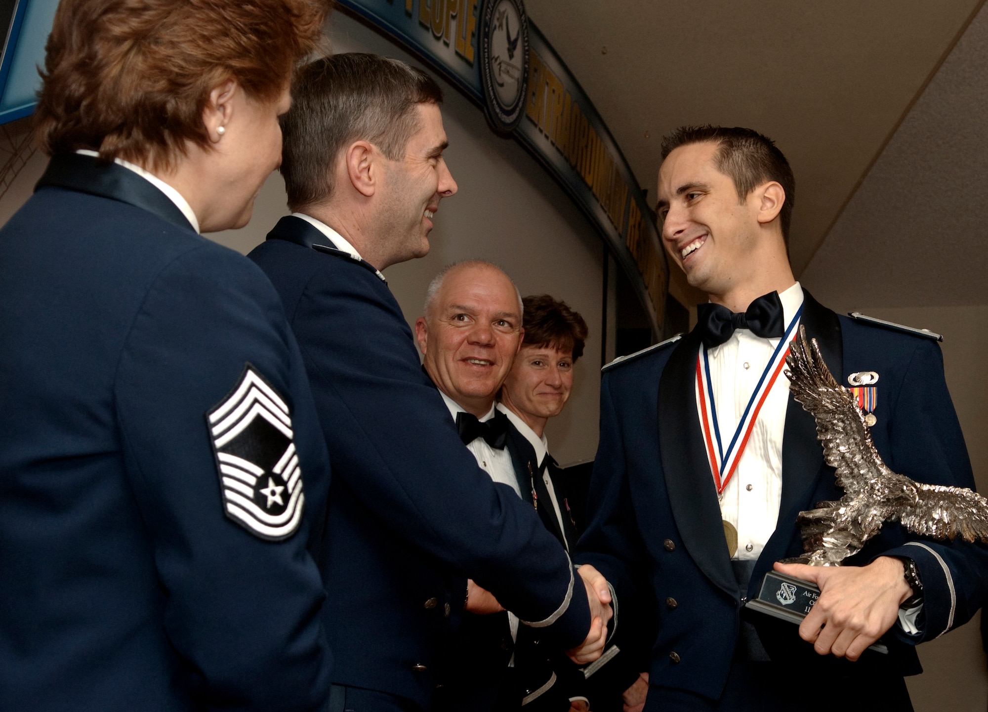 Air Force Flight Test Center Company Grade Officer of the Year, 1st Lt. Joseph J. Sysko, 95th Air Base Wing Comptroller Squadron, is congratulated on stage by both 95th ABW and 412th Test Wing leadership after being presented his award by Brig. Gen. Robert C. Nolan II at the Air Force Flight Test Center Annual Awards Ceremony March 12. Pictured here from left to right are Chief Master Sgt. Rhonda Buening, acting command chief, 95th ABW; Colonel Gregory Schwab, commander, 95th ABW; Chief Master Sgt. Christopher McCollor, command chief, 412th TW; Colonel Dawn Dunlop, commander, 412th TW; and Lieutenant Sysko, deputy commander, Financial Analysis Flight, 95th CPTS. (Air Force by Michael Yncera)