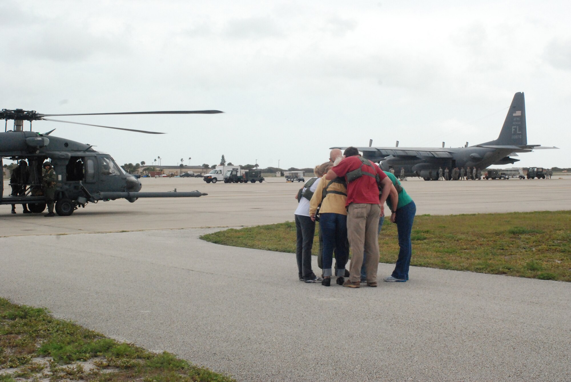 PATRICK AIR FORCE BASE, Fla. - A group of spouses huddled around an HH-60G Pave Hawk helicopter pilot as he gave them a flight brief before getting on board the helicopter. Col. Robert Dunn, 920th Rescue Wing Commander, invited spouses of the Air Force Reservists here to participate in special flights on the Pave Hawk helicopters and HC-130 P/N King airplanes. This event allowed the husbands and wives of hard-working Reservists a glimpse into their drill training weekends and the aircraft they work to maintain. (U.S. Air Force photo/Airman First Class Natasha Dowridge)