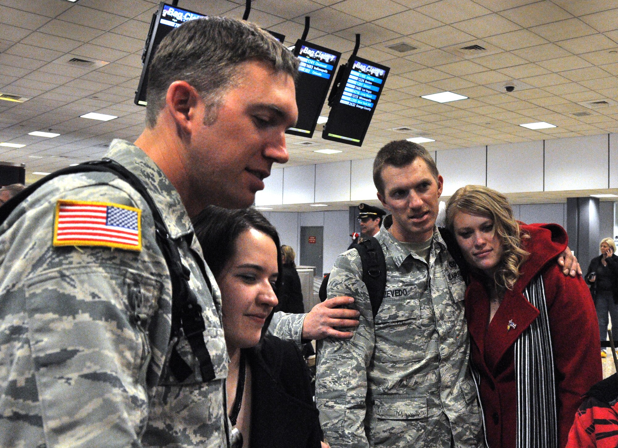 Tech. Sgt. Steven Azevedo and brother, Senior Airman Chris Azevedo, 419th Civil Engineer Squadron, answer questions from the media while holding their wives close. (U.S. Air Force photo/Airman Crystal Charriere) 