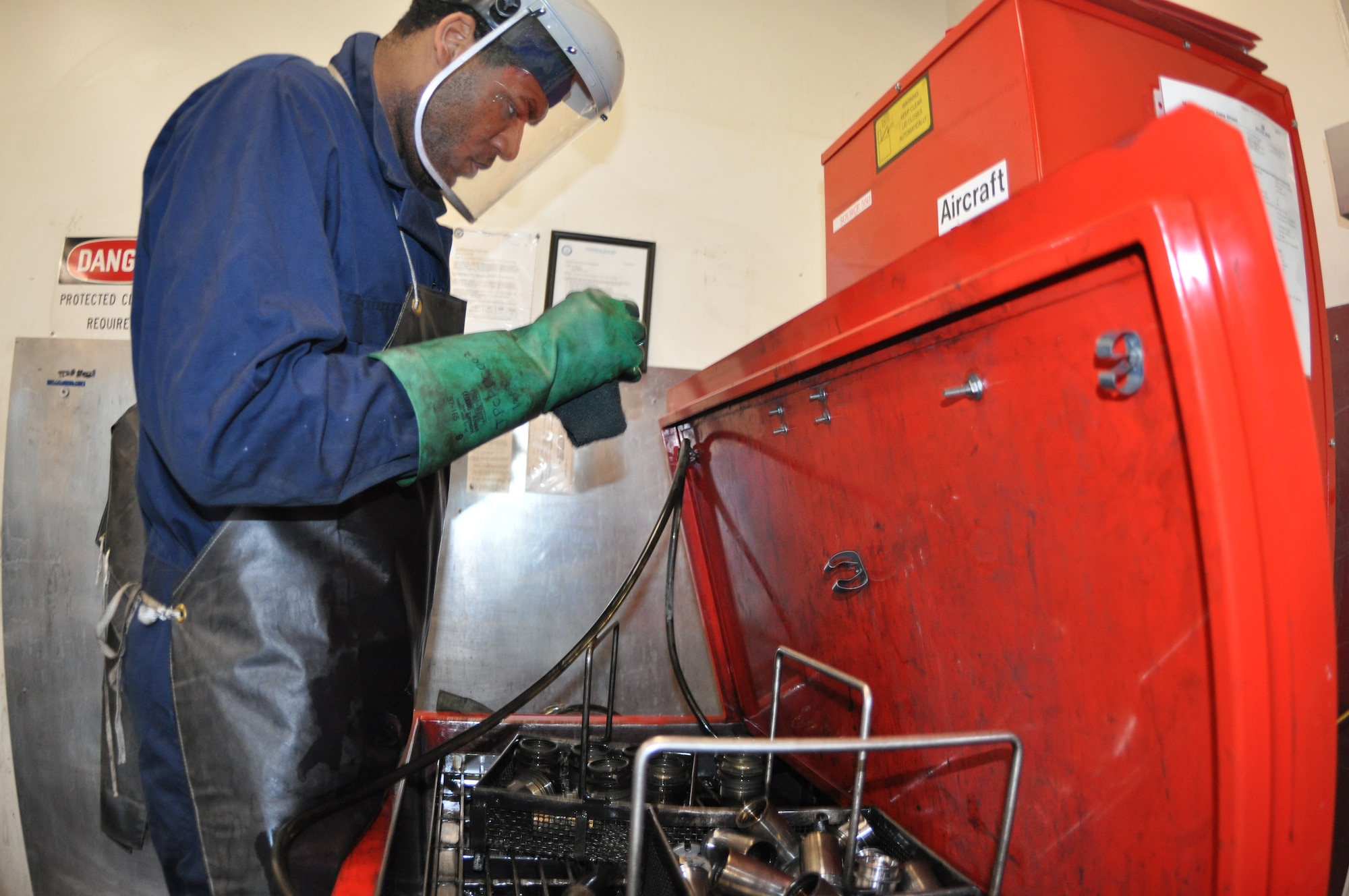 Senior Airman Maliak McEachern, 60th Maintenance Squadron, cleans aircraft brake parts with solvent Tuesday at the hydraulic back shop. U.S. Air Force photo/Staff Sgt. Patrick Harrower