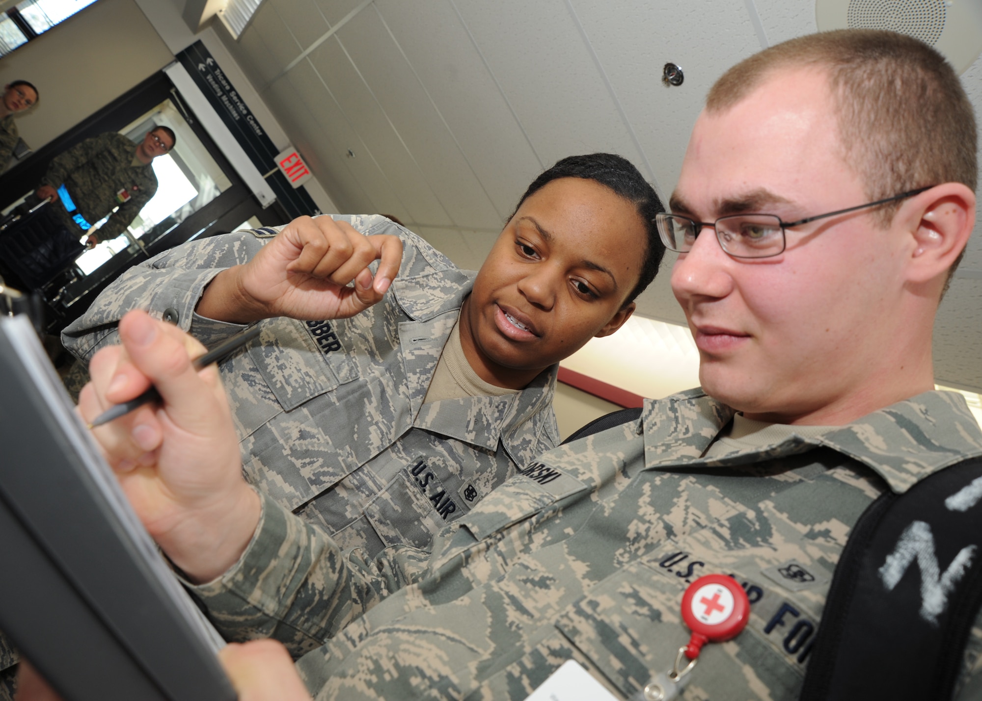 Airman 1st Class Brittney Webber, 22nd Medical Support Squadron health service management journeyman, and Airman 1st Class Derek Piskorski, 22nd MDSS health service management apprentice, write down a patient’s information on a triage form during a tornado major accident response exercise at the base clinic March 10, 2011, McConnell Air Force Base, Kan. The MARE simulated a large number of victims from a tornado, preparing medical Airmen to deal with real crisis scenarios. (U.S. Air Force photo/Senior Airman Maria A. Ruiz)