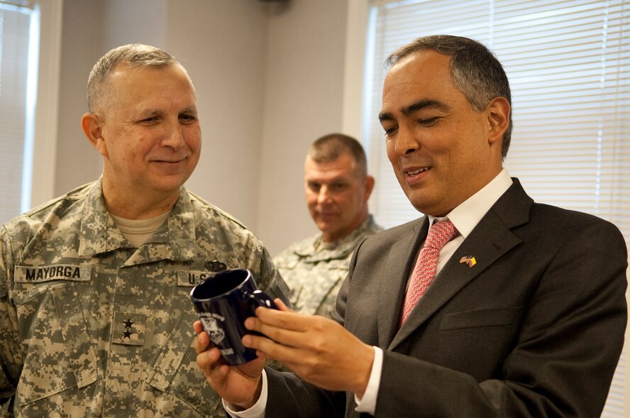 Senor Rodrigo Rivera Salazar, Minister of National Defense, Republic of Colombia admires a commemorative cup from the 136th Airlift Wing presented by Major Gen. Jose Mayorga, Adjutant General, Texas Military Forces, during his visit at the Wing located at NAS Fort Worth JRB, Texas, Jan. 31, 2011. Senor Salazar is here participating in a state partnership program sponsored by the State Department for a demonstration on the Defense Support to Civil Authorities. (U.S. Air Force Photo by Senior Master Sgt. Elizabeth Gilbert/released) 