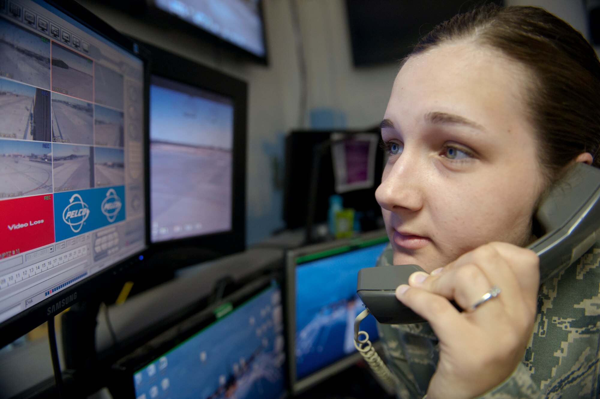 HOLLOMAN AIR FORCE BASE, N.M. -- Staff Sgt. Ashley Smith, 49th Security Forces Squadron, answers a phone call, March 11, 2011, at the Base Defense Operations Center. Sergeant Smith and other BDOC controllers respond to all emergency, medical and assault phone calls as well as monitor closed-circuit televisions of the flightline. (U.S. Air Force photo by Senior Airman Veronica Stamps/Released)