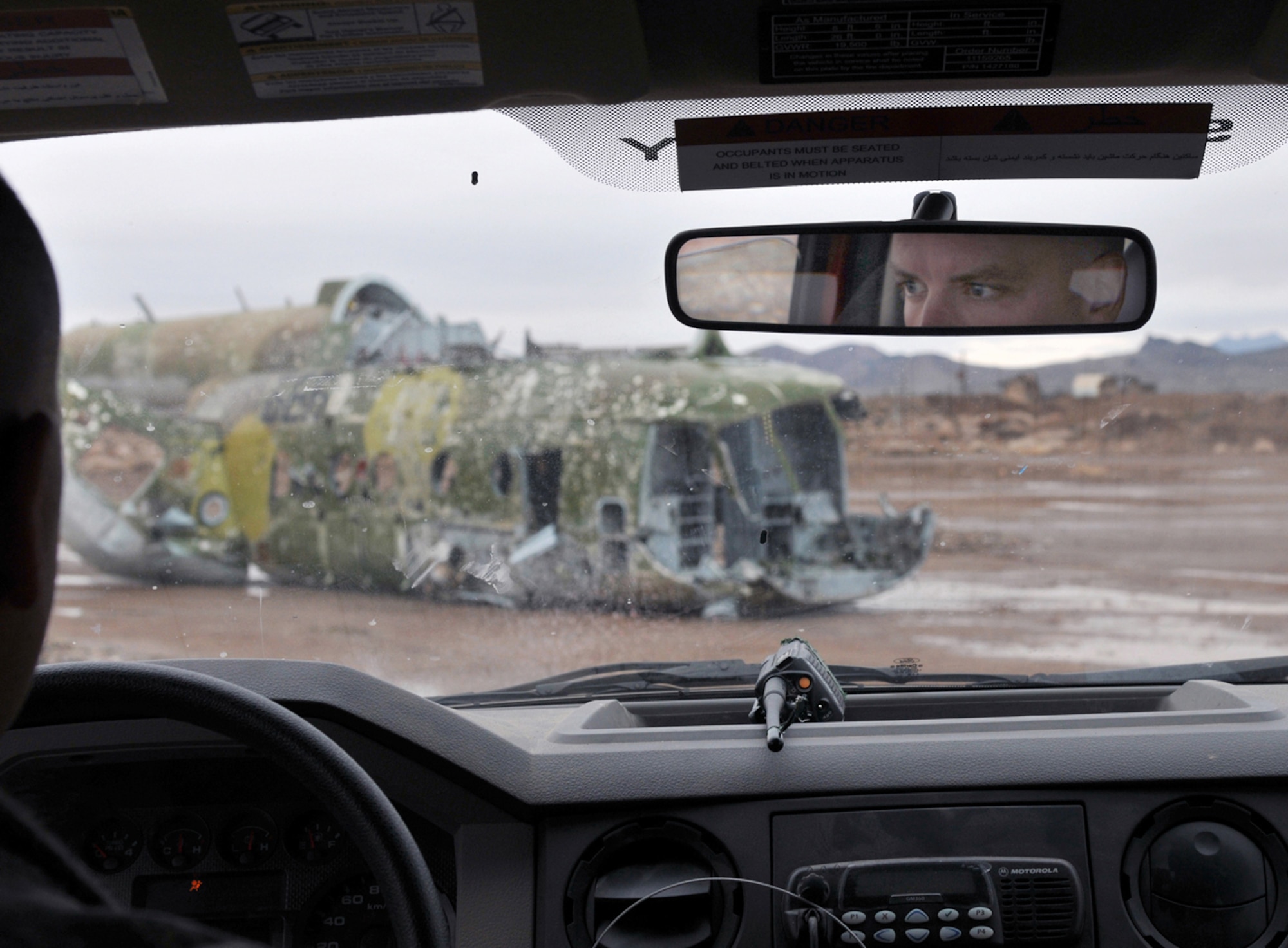 Master Sgt. Matthew Hansen drives a fire truck toward a simulated helicopter crash March 6, 2011, at Shindand Air Base, Afghanistan. Upon arrival, two Afghan airmen whom Sergeant Hansen advises extinguished the fire and simulated taking other emergency actions to the helicopter and pilot. Sergeant Hansen is an 838th Air Expeditionary Advisory Group adviser. (U.S. Air Force photo/Tech. Sgt. Kevin Wallace)