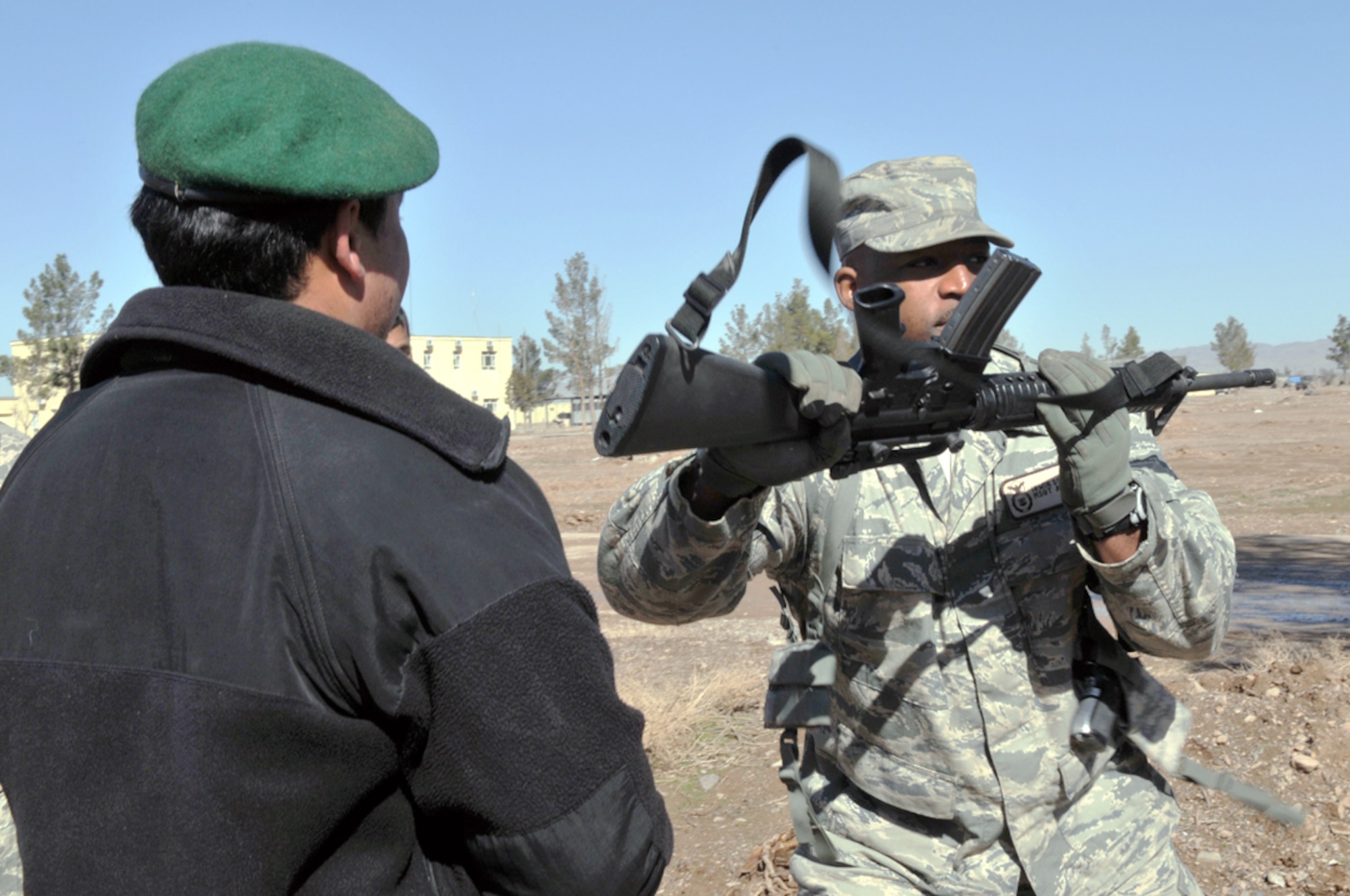 Master Sgt. Irwin Sealy trains an Afghan air force security forces airman on close combat tactics with an M-16 rifle March 7, 2011. Sergeant Sealy, a security forces adviser with the 838th Air Expeditionary Advisory Group, is deployed from the U.S. Air Force Academy in Colorado Springs, Colo. (U.S. Air Force photo/Tech. Sgt. Kevin Wallace)