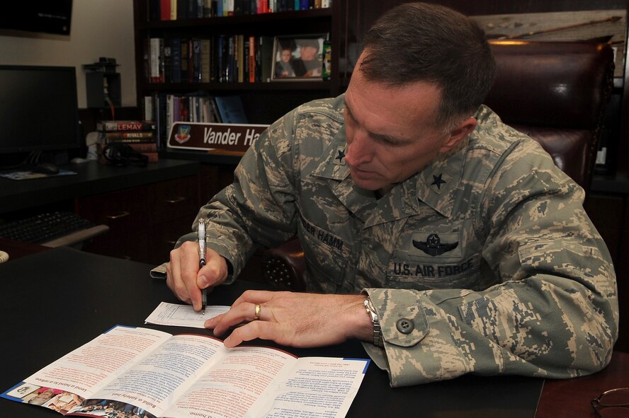 WHITEMAN AIR FORCE BASE, Mo. -- Brig. Gen. Scott Vander Hamm, 509th Bomb Wing commander, makes the first donation to the Air Force Assistance Fund March 14, 2011. The campaign runs from March 21 to May 2 and benefits the Air Force Aid Society, Air Force Village, Air Force Enlisted Village and General and Mrs. Curtis LeMay Foundation. Members can contact their unit representative for more information. The project officers are Capt. Troy Combs, 13th Bomb Squadron and Master Sgt. Tim Miller, 509th Security Forces Squadron. (U.S. Air Force photo by Senior Airman Kenny Holston)(Released)   