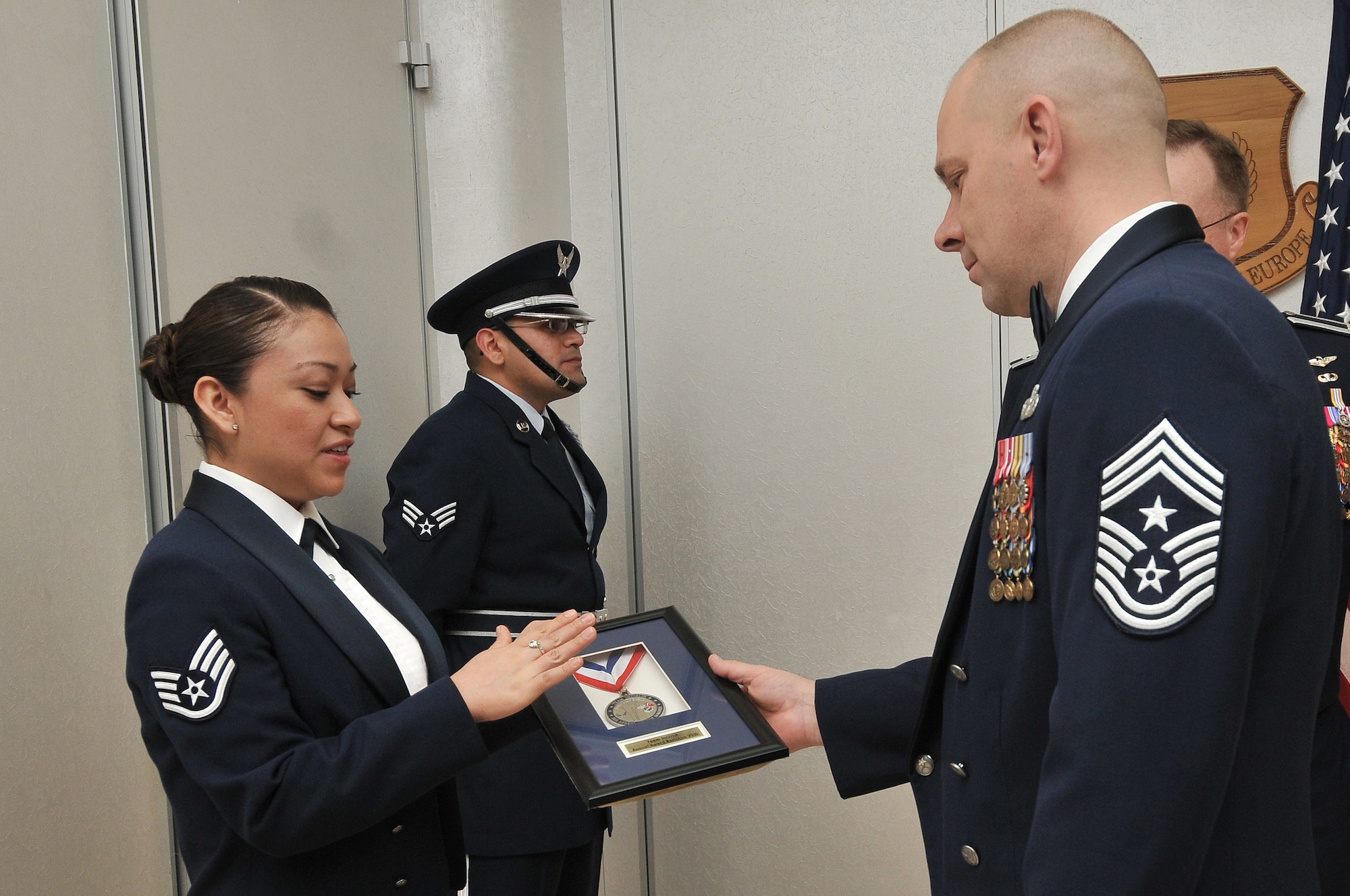 Staff Sgt. Teresa Smith, from the 39th Air Base wing, displays the 2010 Incirlik Annual Awards shadow box to Chief Master Sgt. Dennis Vannorsdall, the 3rd Air Force command chief, prior to the ceremony Feb. 25, 2011, at Incirlik Air Base, Turkey. The annual awards banquet is held to honor Team Incirlik personnel who excelled in the 2010 calendar year. (U.S. Air Force photo by Staff Sgt. Alexandre Montes)