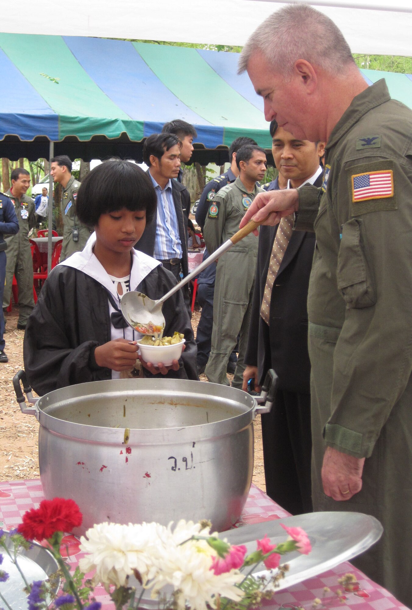 KORAT, Thailand - Col. Robert Huston and Royal Thai Air Force Group Capt. Thawonwat Chantanakom serve soup during a community outreach event at the Ang Huai Yang School in Korat, Thailand, March 16. Colonel Huston and Group Captain Thawonwat are exercise directors for Cope Tiger 2011, an annual, multilateral, joint field training exercise currently being conducted at Korat and Udon Thani Royal Thai Air Bases March 14 through 25. (U.S. Air Force Photo/ Capt. Kirsten Udd)