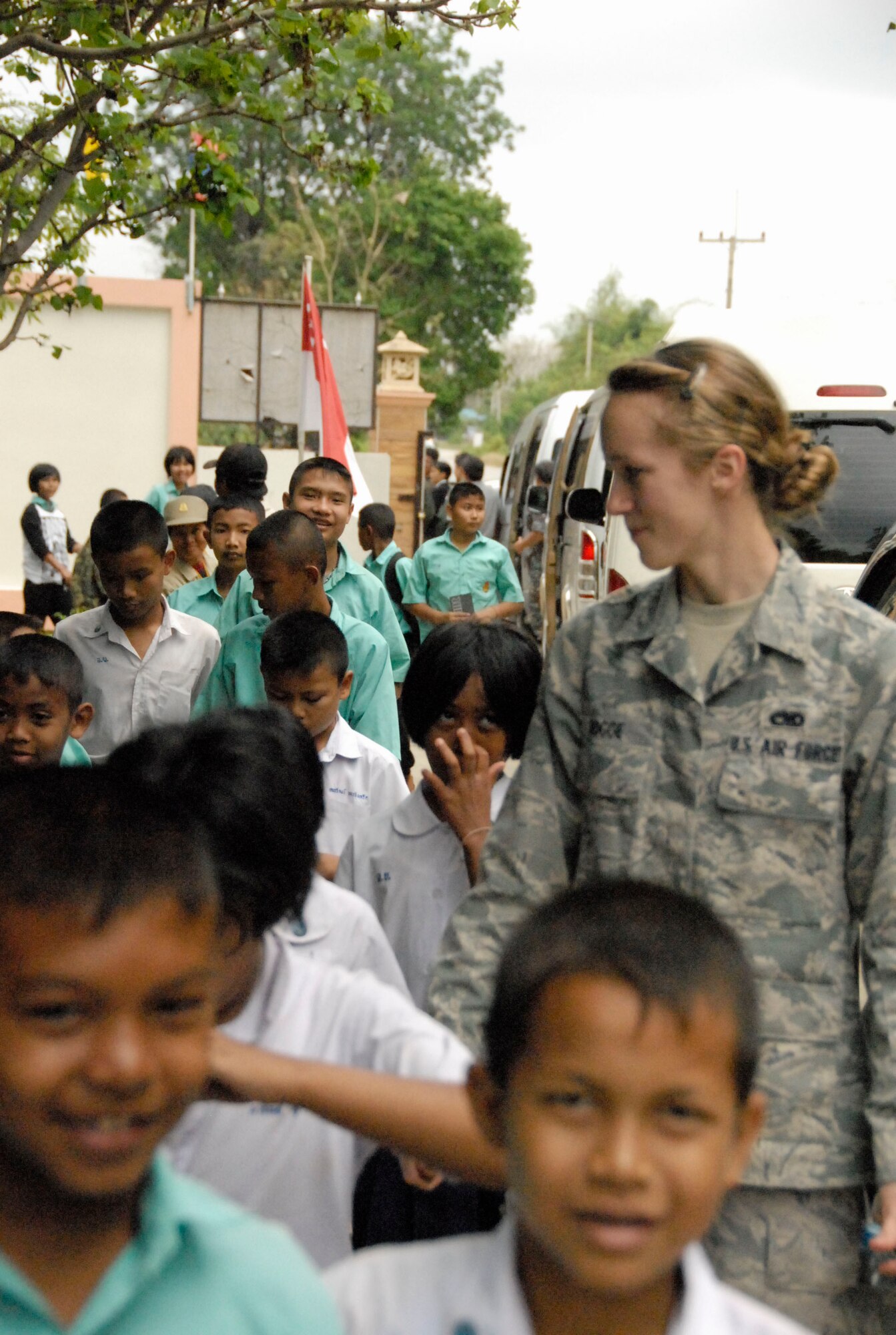 KORAT, Thailand - Airman 1st Class Stephanie Rogge spends time with children from the Ang Huai Yang School during a community outreach event in Korat, Thailand, March 16. Airman Rogge is a munitions airman with the 44th Air Expeditionary Fighter Squadron, deployed from Kadena Air Base, Japan, in support of Cope Tiger 2011, an annual, multilateral, joint field training exercise currently being conducted at Korat and Udon Thani Royal Thai Air Bases March 14 through 25. (U.S. Air Force Photo/ Capt. David Herndon)