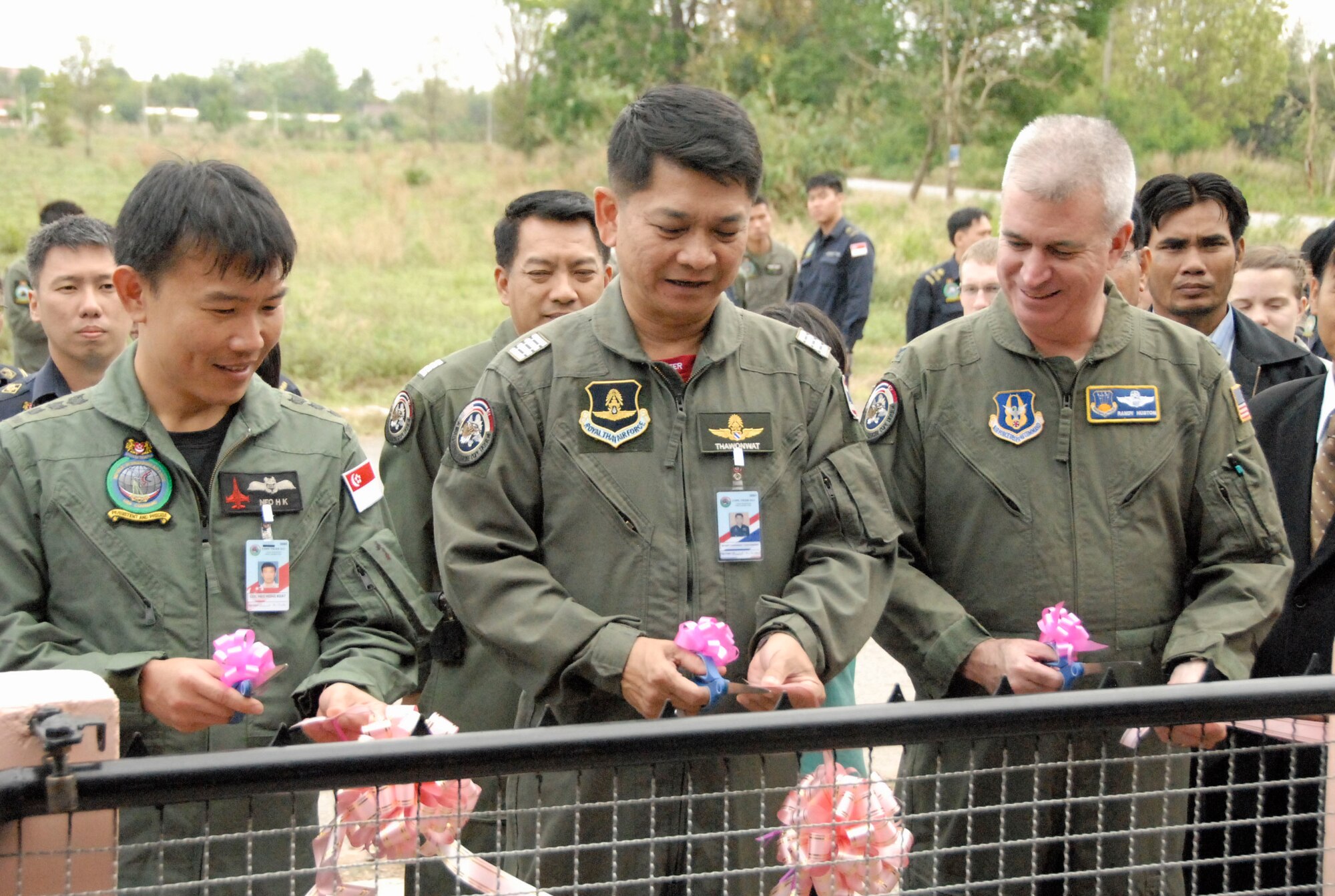Col. Robert Huston cuts the ribbbon with Republic of Singapore Air Force Col. Neo Hong Keat and Royal Thai Air Force Group Capt. Thawonwat Chantanakom, as they open a newly-renovated school bus stop during a community outreach event at the Ang Huai Yang School in Korat, Thailand, March 16. Colonel Huston, Colonel Neo and Group Captain Thawonwat are exercise directors for Cope Tiger 2011, an annual, multilateral, joint field training exercise currently being conducted at Korat and Udon Thani Royal Thai Air Bases March 14 through 25. (U.S. Air Force Photo/ Capt. David Herndon)