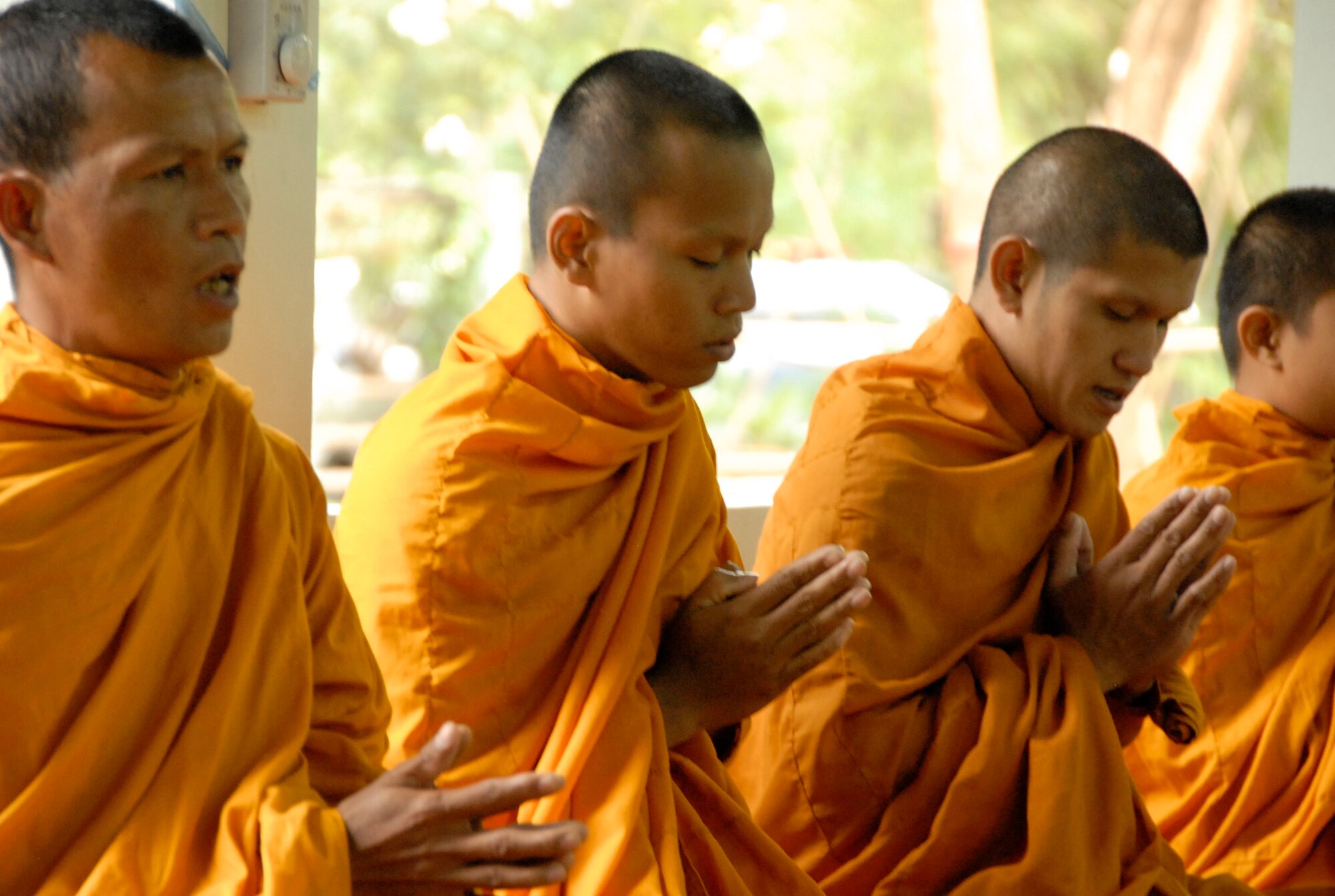 KORAT, Thailand - Thai Monks chant during a community outreach event at Ang Huai Yang School in Korat, Thailand, March 16. Servicemembers from the U.S., Republic of Singapore, and Royal Thai Air Forces participated in the event while supporting Cope Tiger 2011, an annual, multilateral, joint field training exercise currently being conducted at Korat and Udon Thani Royal Thai Air Bases March 14 through 25. (U.S. Air Force Photo/ Capt. David Herndon)