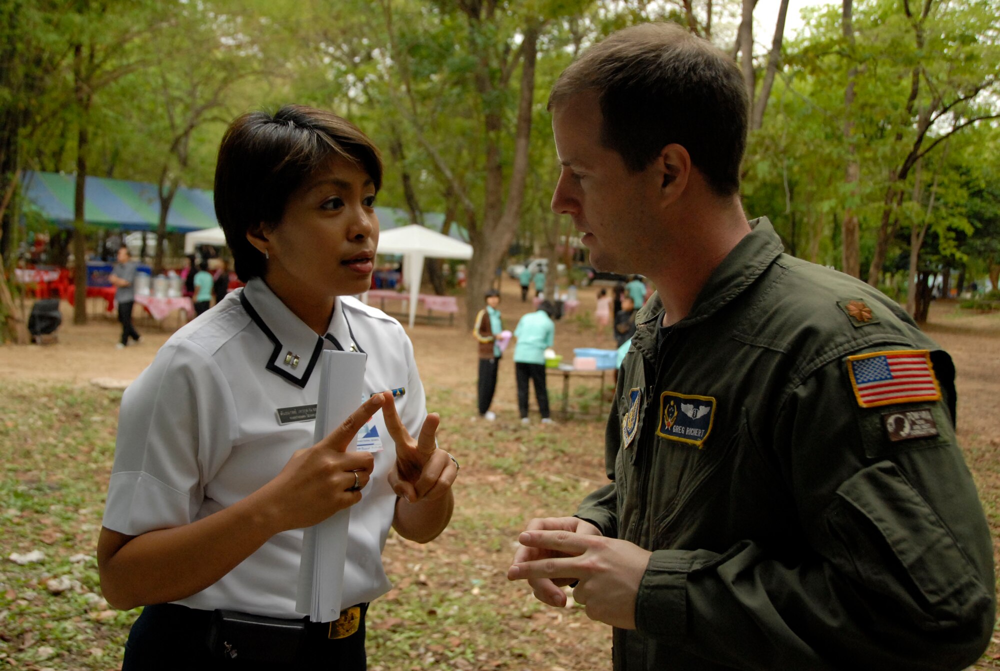 KORAT, Thailand - Maj. Greg Richert confirms event details with Flight Lt. Khanthaman Devakul, correspondent for the Royal Thai Air Force, before a community outreach event at Ang Huai Yang School in Korat, Thailand, March 16. Major Richert is the Chief of Aerospace Medicine at 13th Air Force, Joint Base Pearl Harbor-Hickam, Hawaii, and medical lead for Exercise Cope Tiger 2011, an annual, multilateral, joint field training exercise currently being conducted at Korat and Udon Thani Royal Thai Air Bases March 14 through 25. (U.S. Air Force Photo/ Capt. David Herndon)