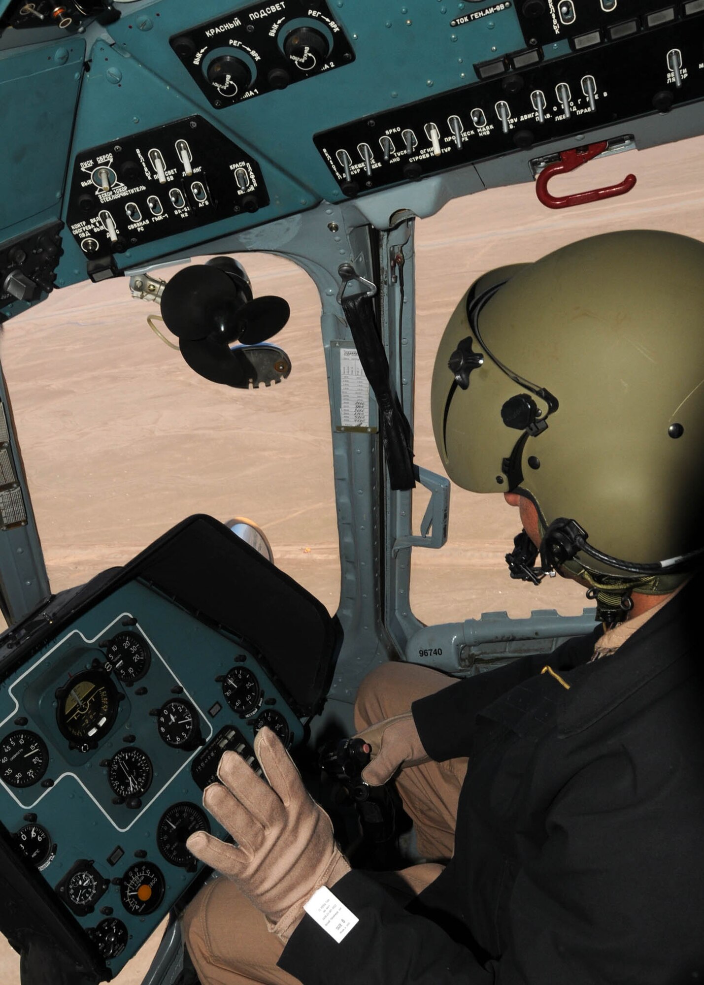 SHINDAND, Afghanistan - Afghan Air Force Col. Mohammad Rahim Azimy, a Mi-17 transport instructor pilot, trains a AAF student pilot on flying procedures at the AAF training center in Shindand, Afghanistan. This was the first time that an AAF instructor pilot served as chief instructor for an Afghan pilot. (U.S. Navy photo by Mass Communications Specialist 3rd Class Jared E. Walker)