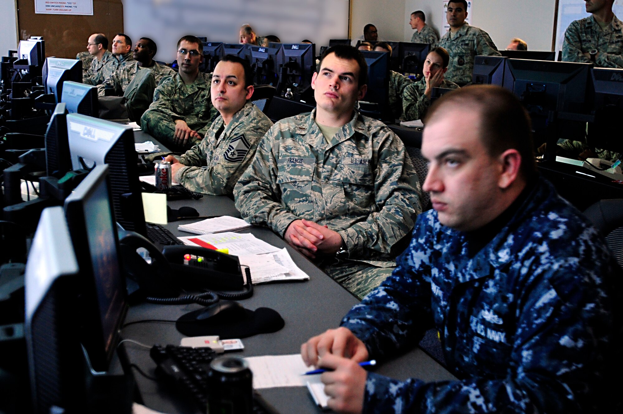MISAWA AIR BASE, Japan -- Members in the Emergency Operations Center listen as other EOC members report to the commander on the activities of their specific function Mar. 16. The EOC operates 24/7 as the hub of recovery operations during humanitarian relief and base recovery operations. (U.S. Air Force photo by Staff Sgt. Marie Brown\Released)
