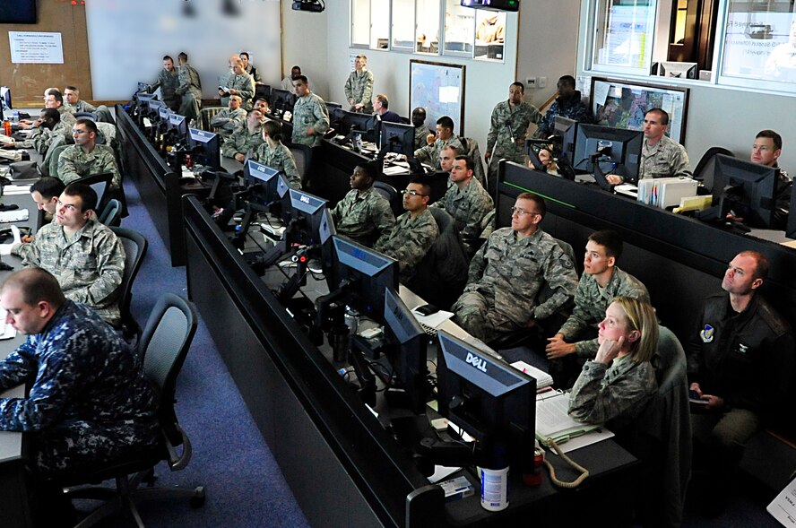 MISAWA AIR BASE, Japan -- Members of the Emergency Operations Center read slides while they listen to the Commander's Update Briefing Mar. 16. The EOC is the command and control hub for emergency operations on base. (U.S. Air Force photo by Staff Sgt. Marie Brown\Released)
